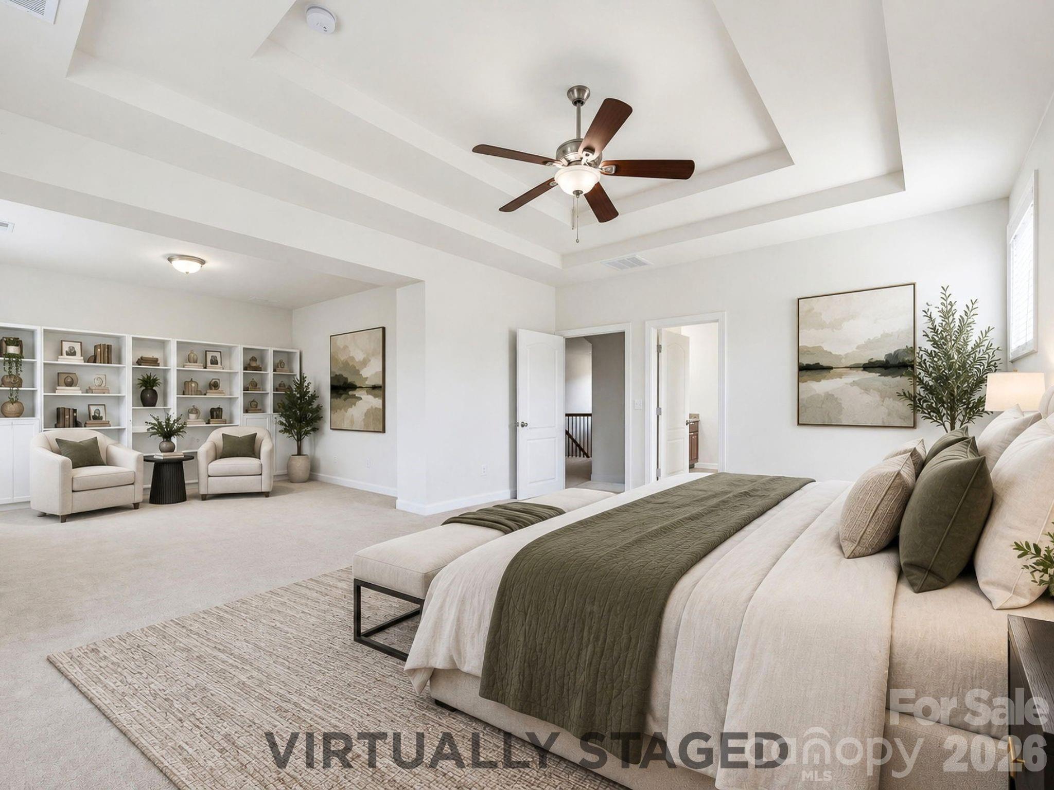 Virtually staged to showcase the suite's scale, the primary bedroom opens naturally into a private lounge ready for reading, relaxing, or quiet morning coffee, which overlooks the beautiful pergola and fire pit in the expansive backyard - 8315 Breton Way, Harrisburg