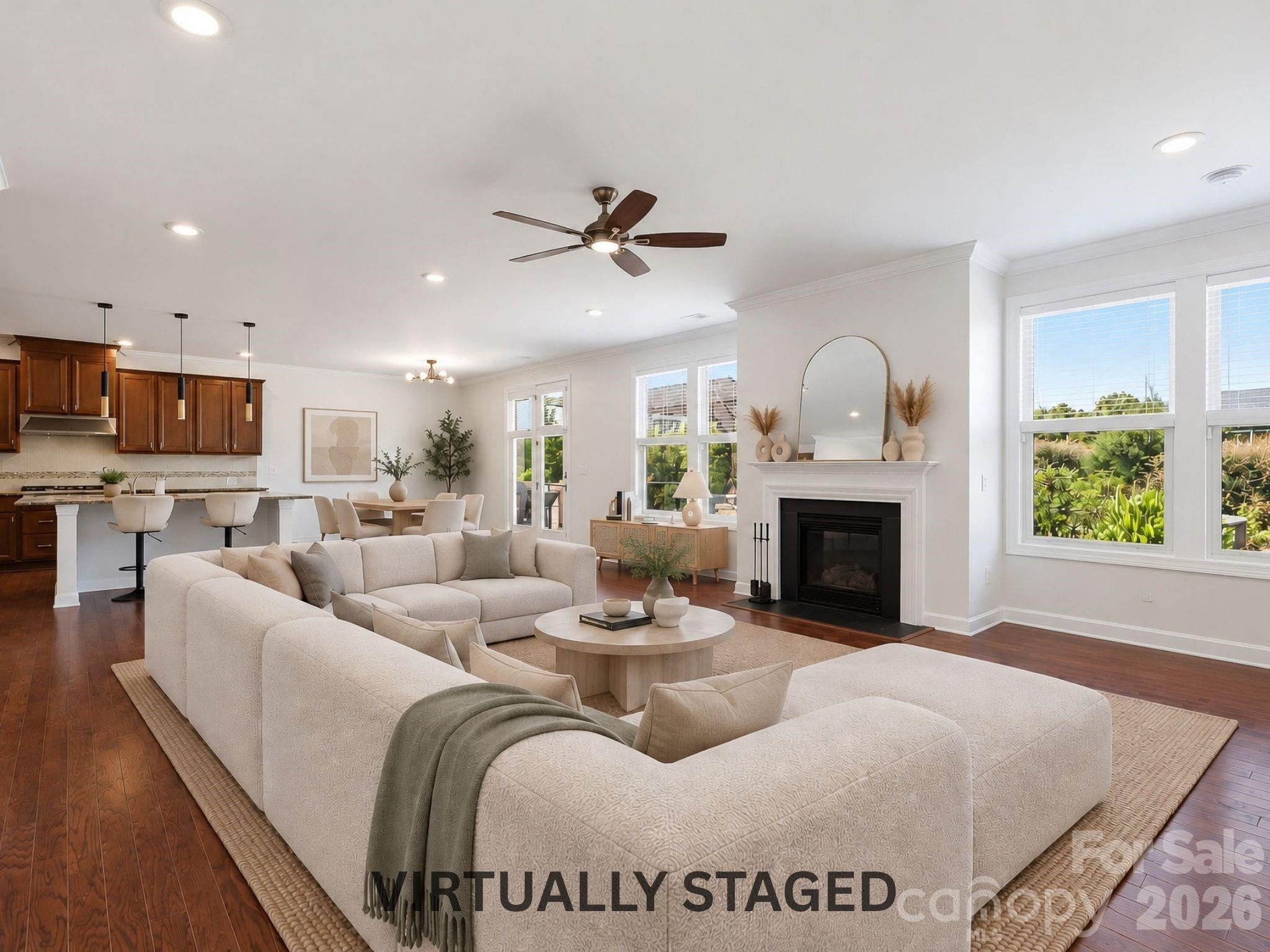 Virtually staged to show the possibilities, the open family room is made for movie nights, relaxed weekends, and time spent together by the fireplace. - 8315 Breton Way, Harrisburg
