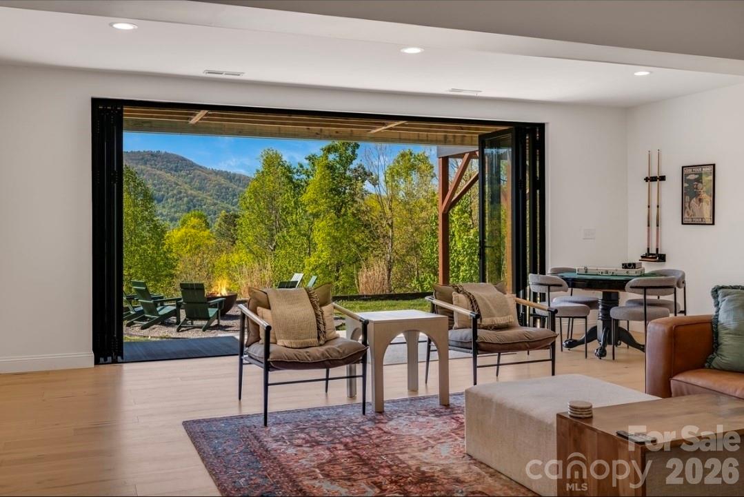 Lower Level Living Area w Accordion Sliding Glass Doors - 58 Bird Creek Estates Road, Black Mountain