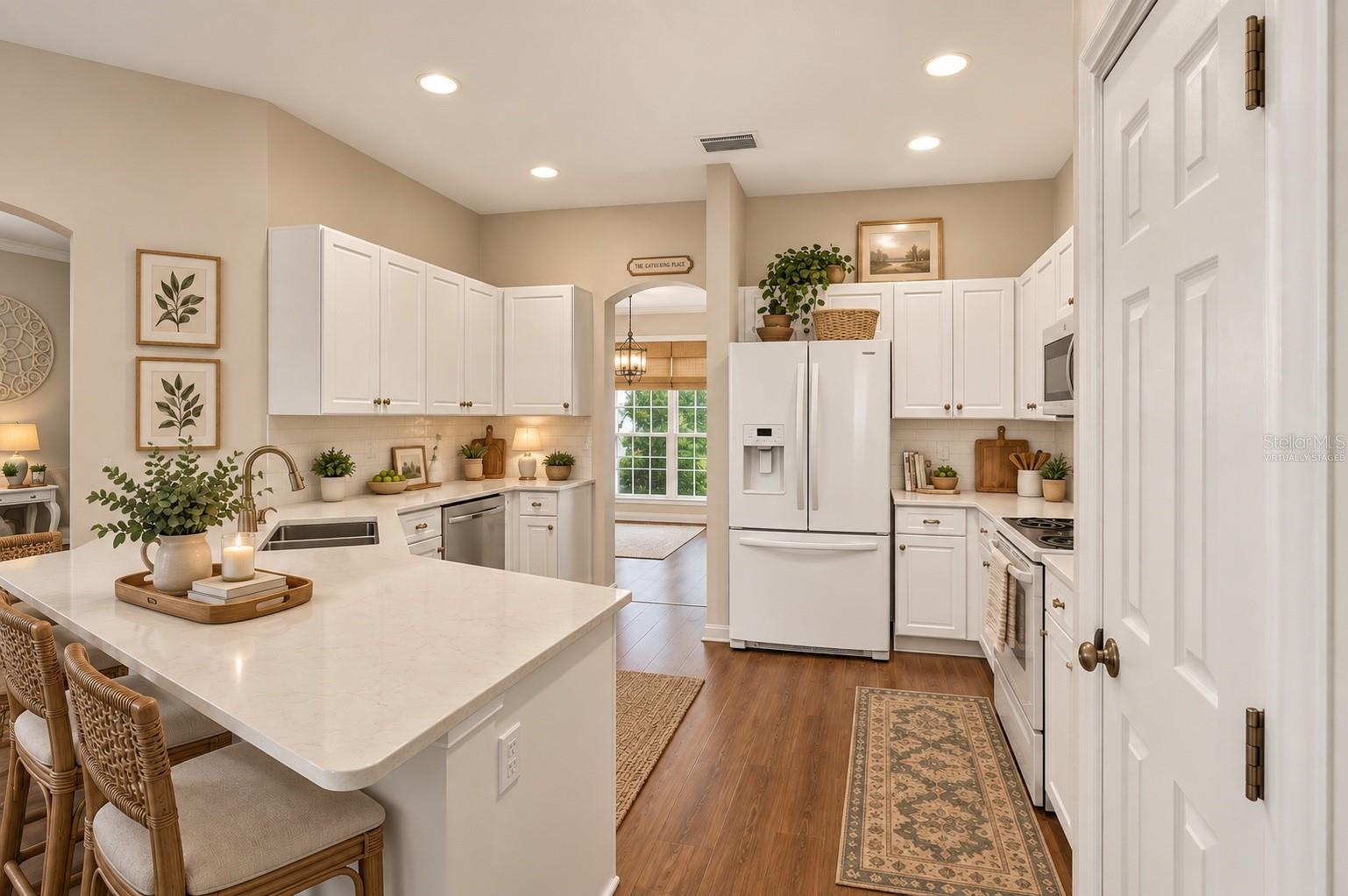 Large kitchen with wood floors, virtually staged - 6618 SW 83RD TER, GAINESVILLE
