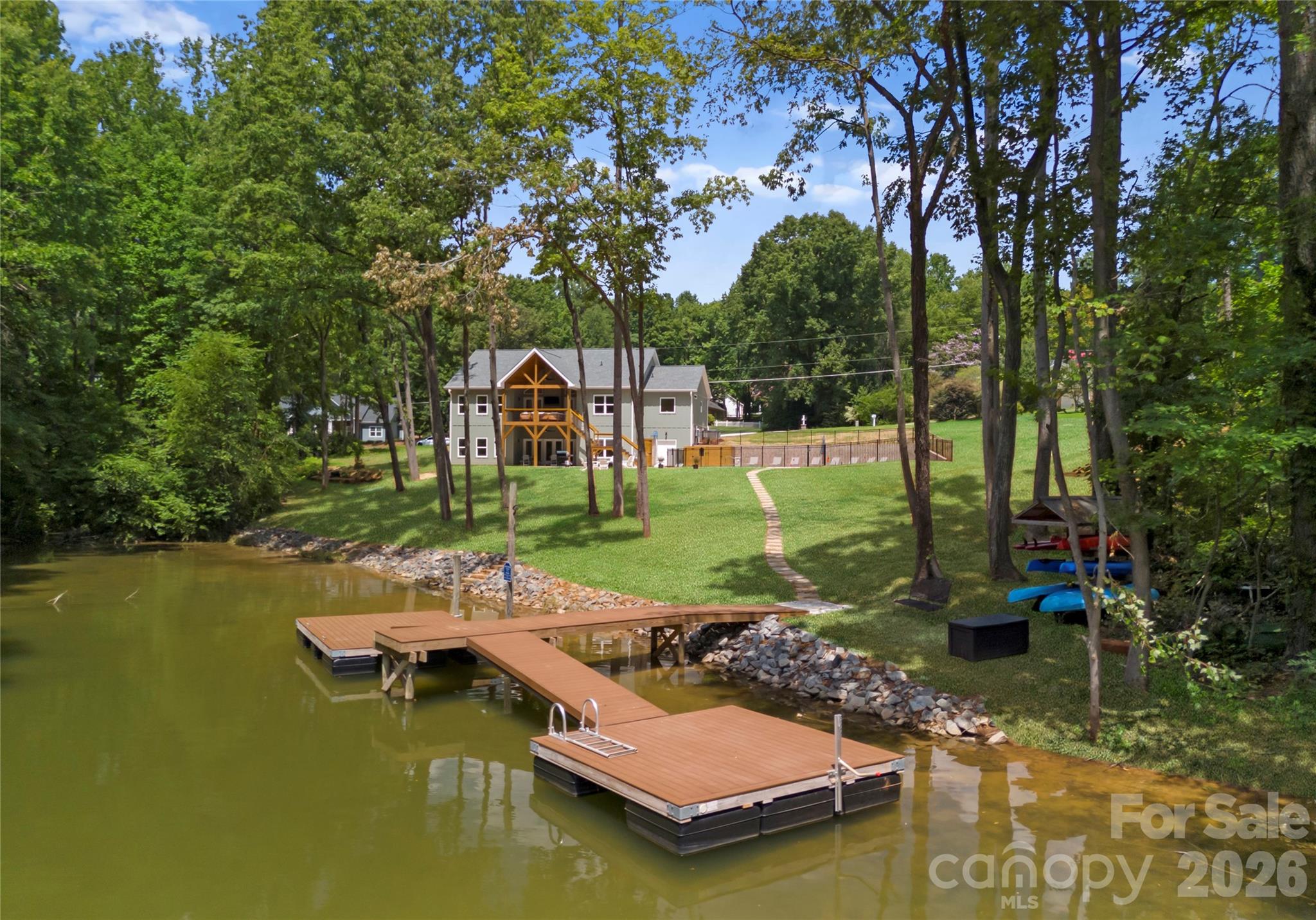 The double-sided private dock invites you slip away onto the water by boat, kayak, or paddle board. - 143 Hideaway Lane, Mooresville