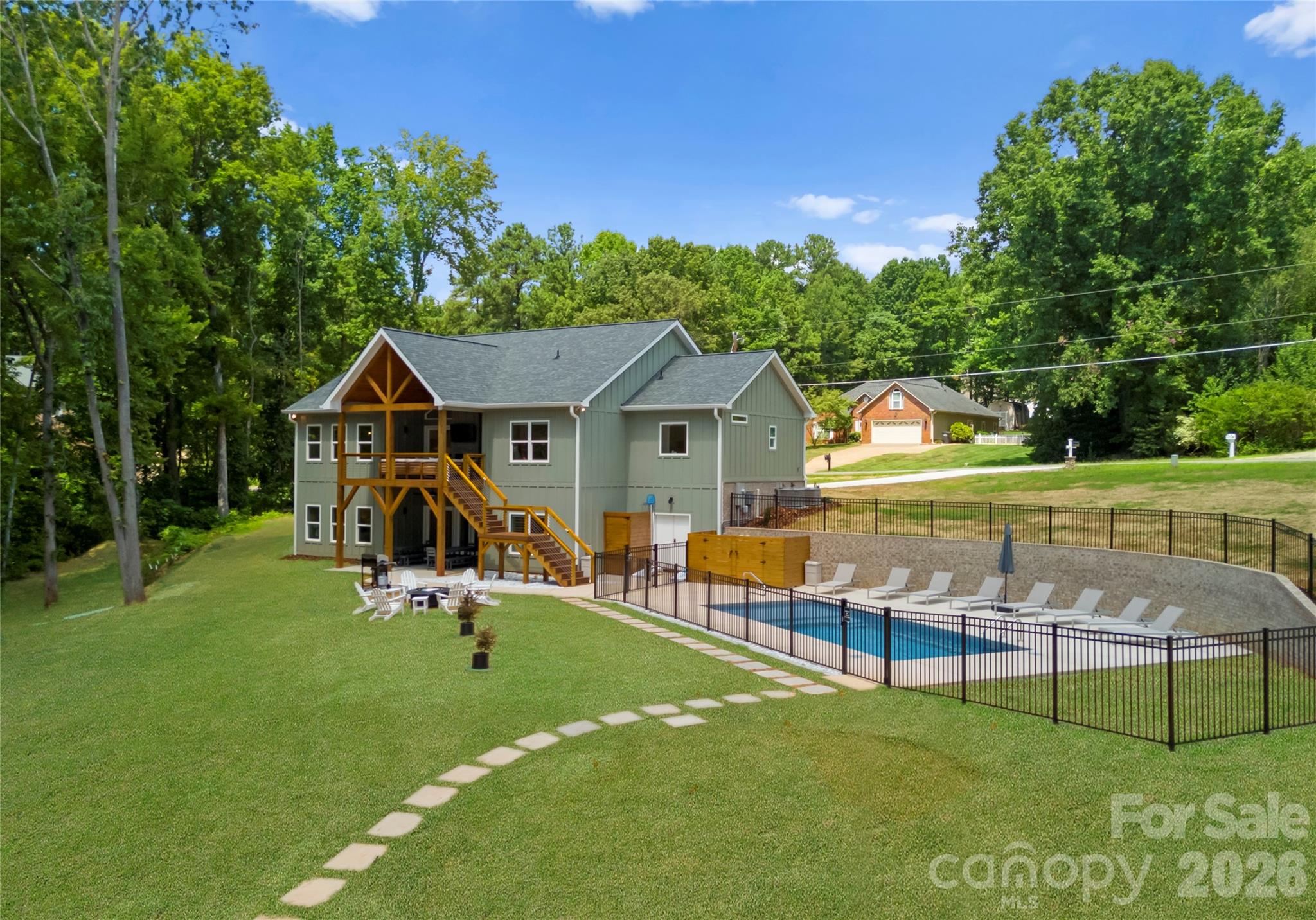 From the covered porch to the fenced salt-water pool, this property is designed for long afternoons outside and easy entertaining. - 143 Hideaway Lane, Mooresville