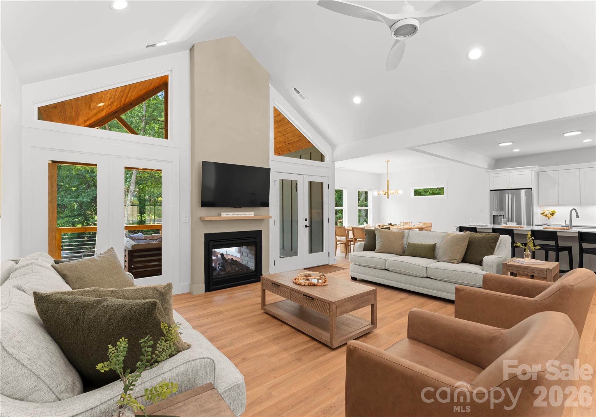 The living room flows into the dining area and kitchen, creating a welcoming space to gather after a day on the lake. - 143 Hideaway Lane, Mooresville