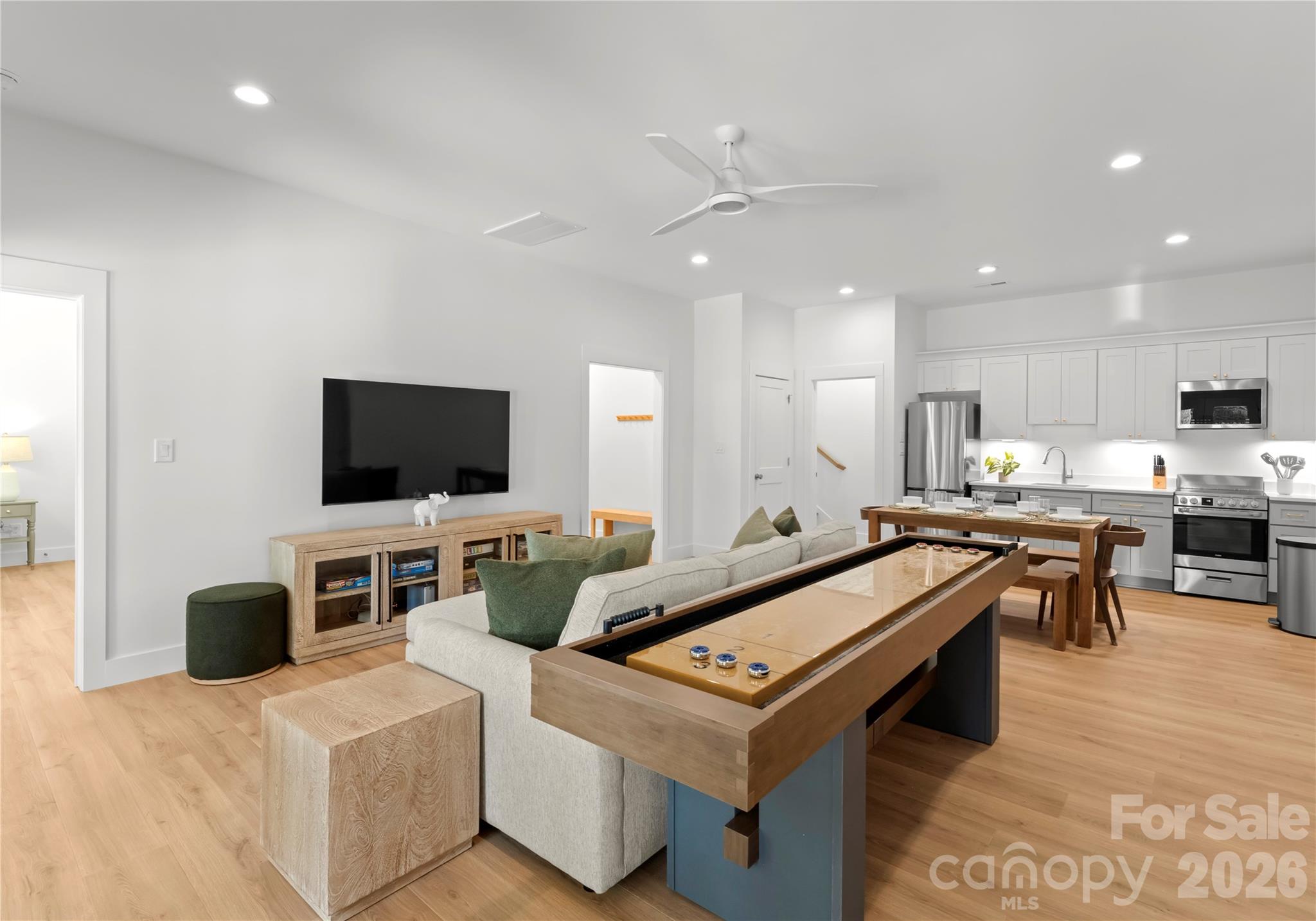 A shuffleboard table gives this spacious lounge a playful touch and another place for guests to gather. - 143 Hideaway Lane, Mooresville