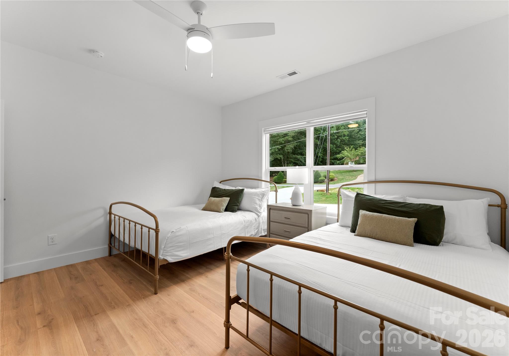 Two beds and a large window make this bedroom a comfortable retreat. - 143 Hideaway Lane, Mooresville