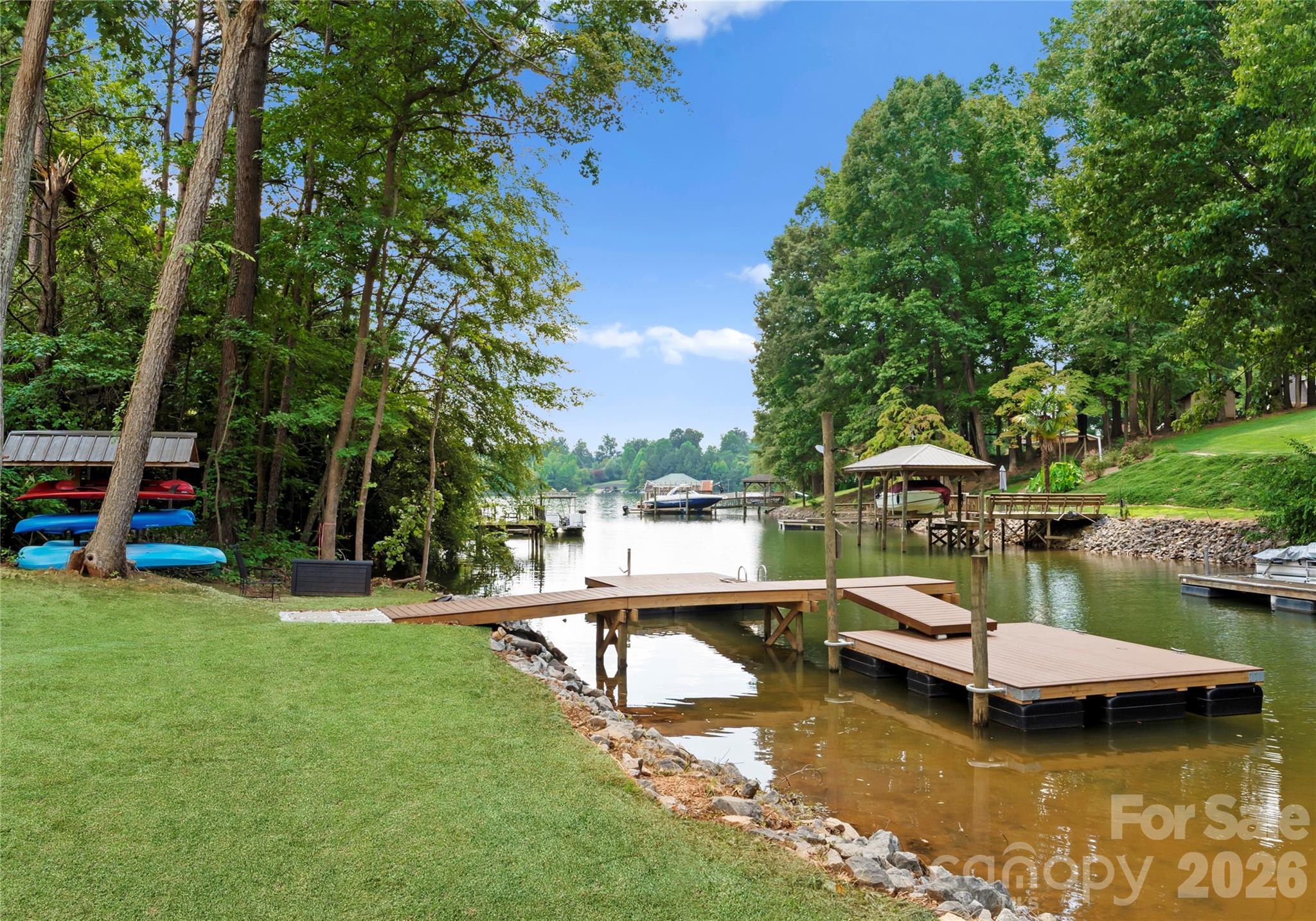 The two-sided dock sits along a quiet, tree-lined cove, with space to relax by the water and enjoy the lake. - 143 Hideaway Lane, Mooresville