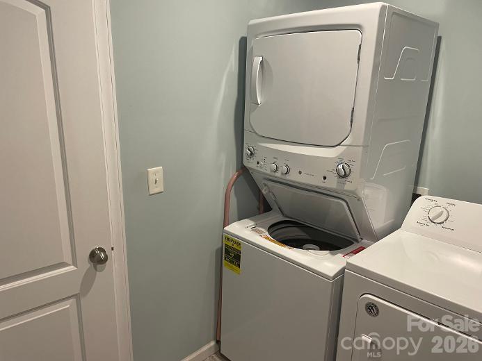 Stackable washer/dryer located in Primary Closet and included with house. - 1670 Dale Earnhardt Boulevard, Kannapolis