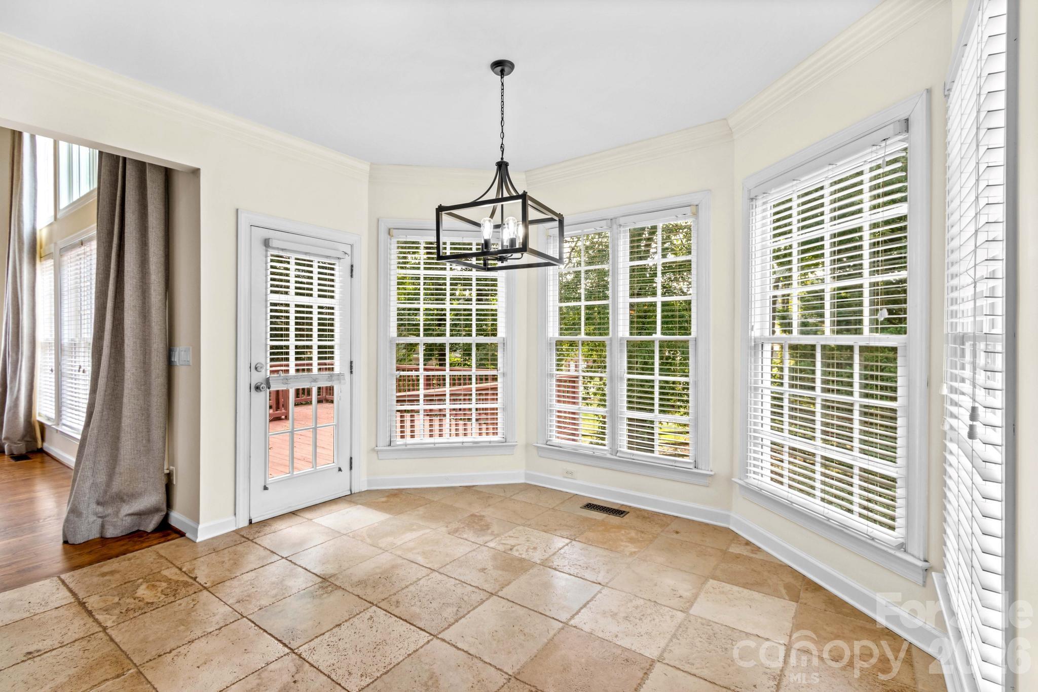 Breakfast area overlooks mature trees and has door leading to wood deck. - 12822 Cadgwith Cove Drive, Huntersville