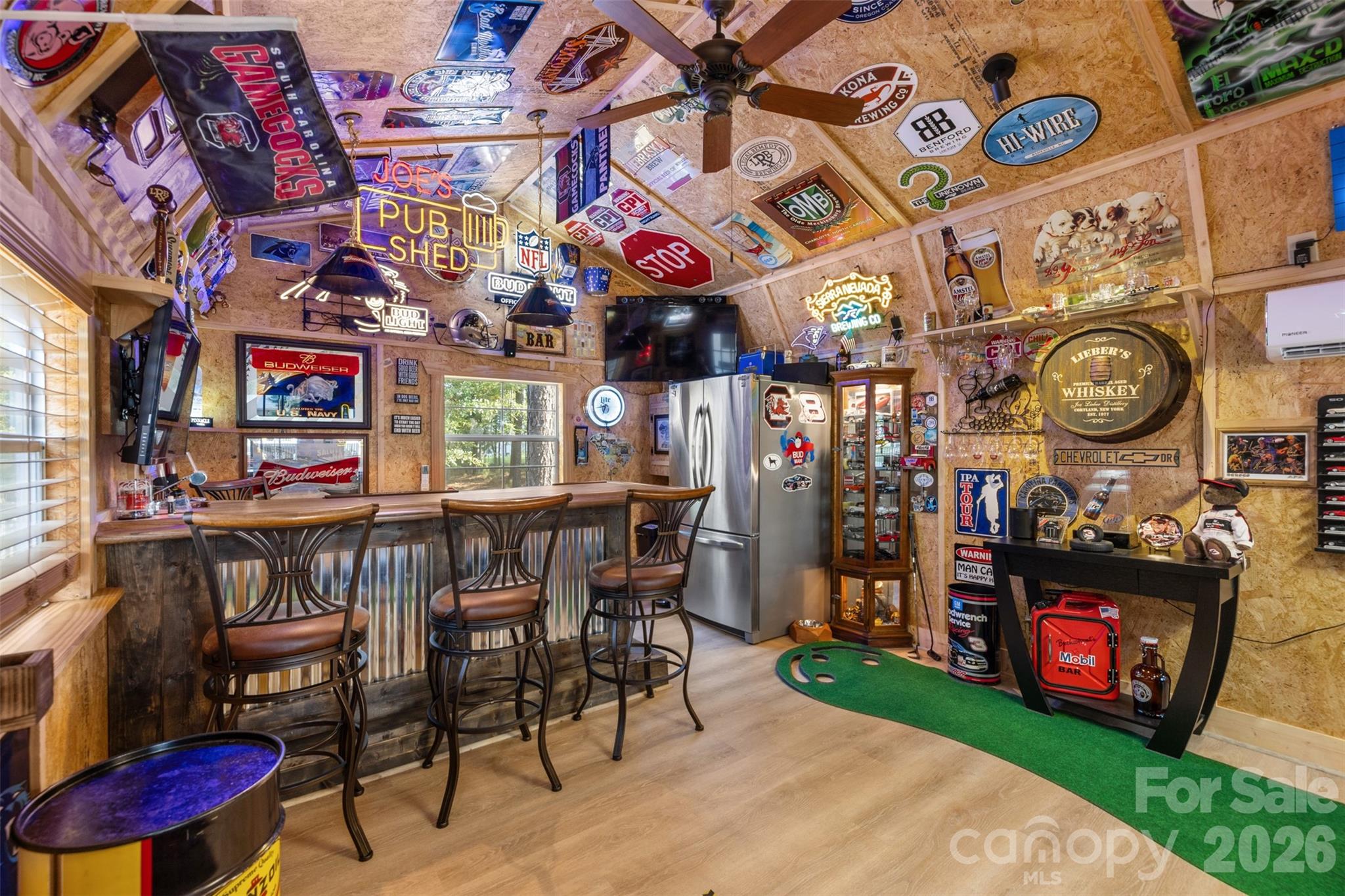 Custom backyard pub complete with bar seating, beverage storage, and mini-split HVAC - 1604 Aragon Beach Road, Rock Hill