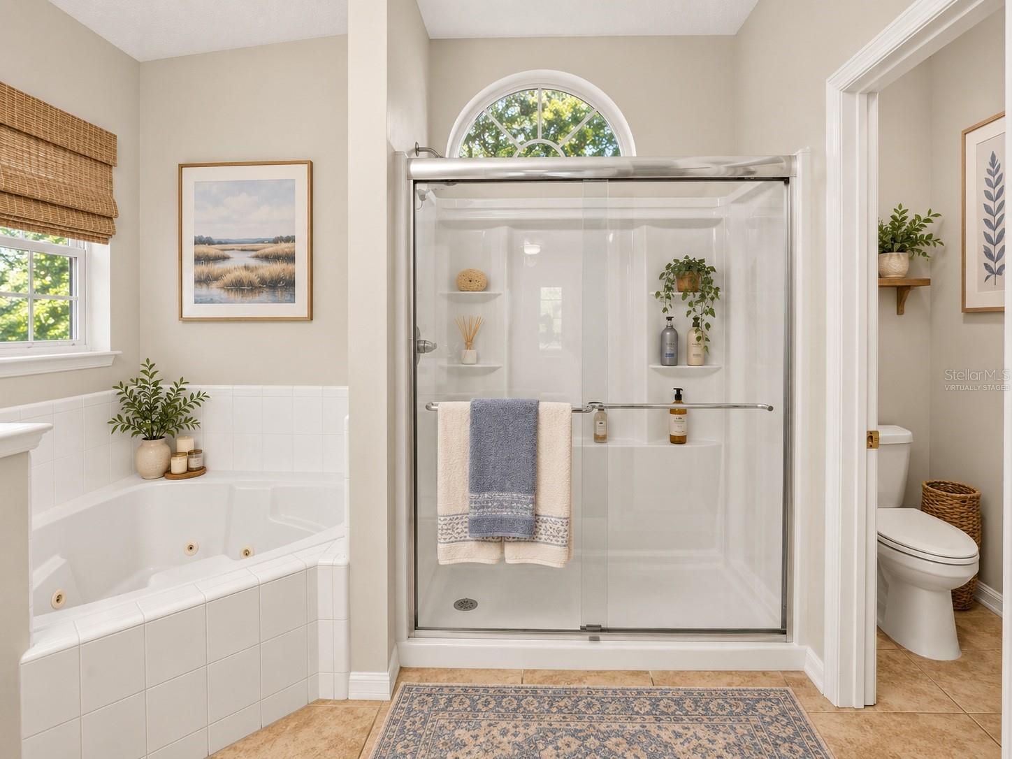 Soaking tub and separate shower in primary bathroom, virtually staged - 6618 SW 83RD TER, GAINESVILLE