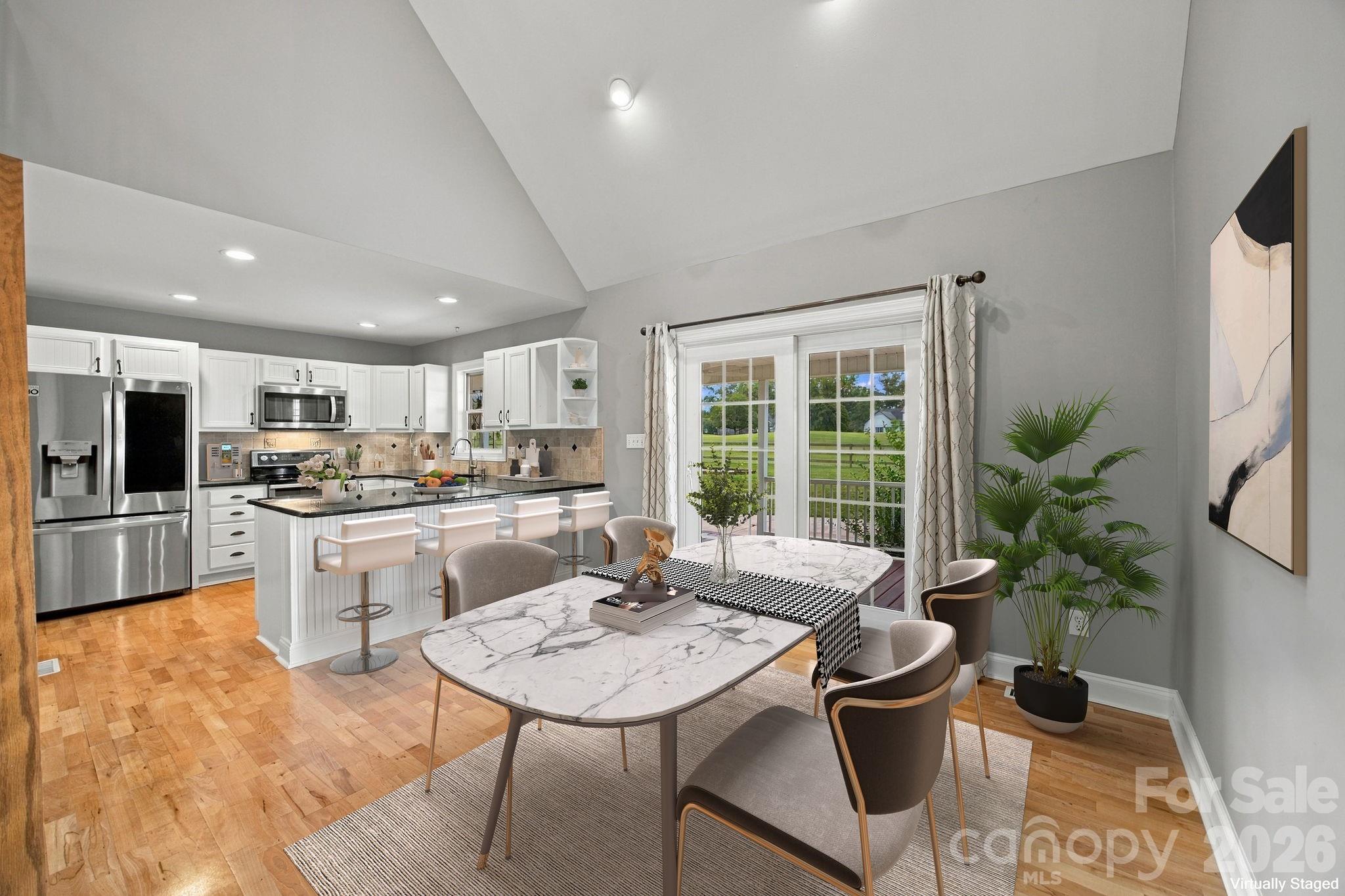 Virtually staged to showcase the breakfast area overlooking the backyard and golf course. - 122 Wood Duck Loop, Mooresville