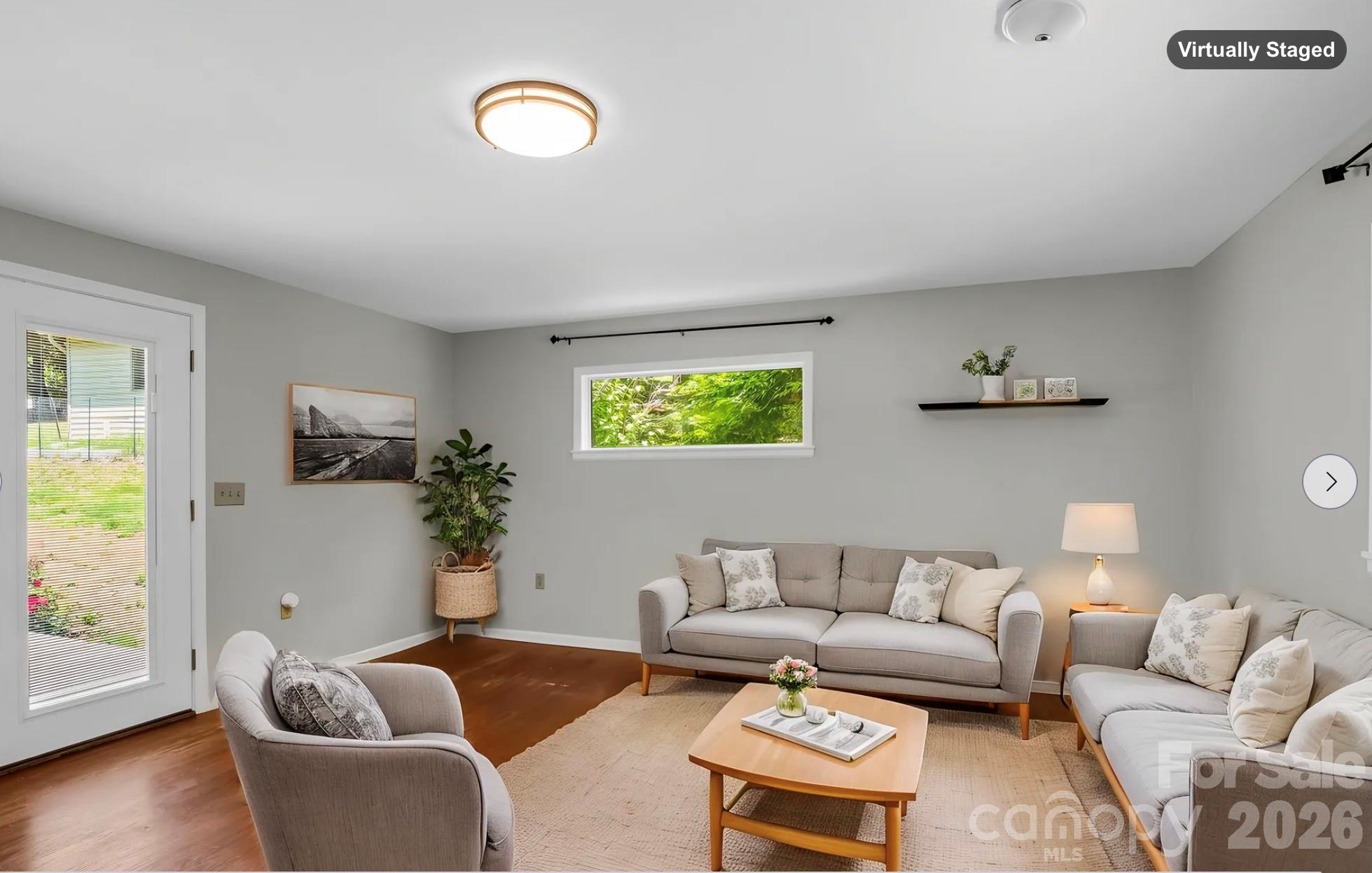 Family Room off of Living Room, doors open to back patio (virtually staged) - 35 Chastain Hill Road, Mills River