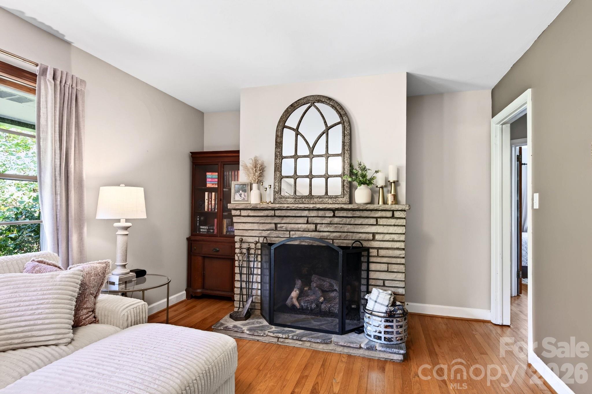 Spacious living room with hardwood floors, large windows and gas fireplace - 109 Wilshire Drive, Asheville