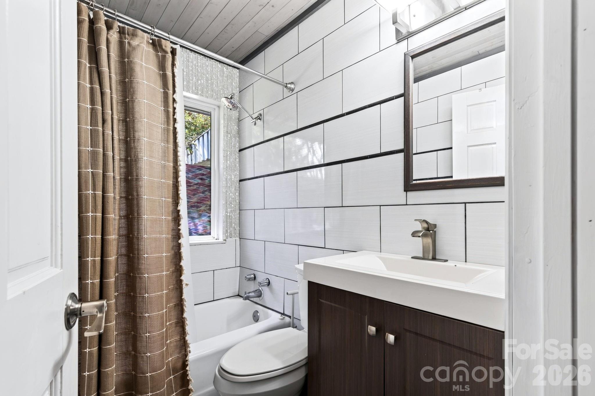 Updated main-level full bath with contemporary tile - 109 Wilshire Drive, Asheville