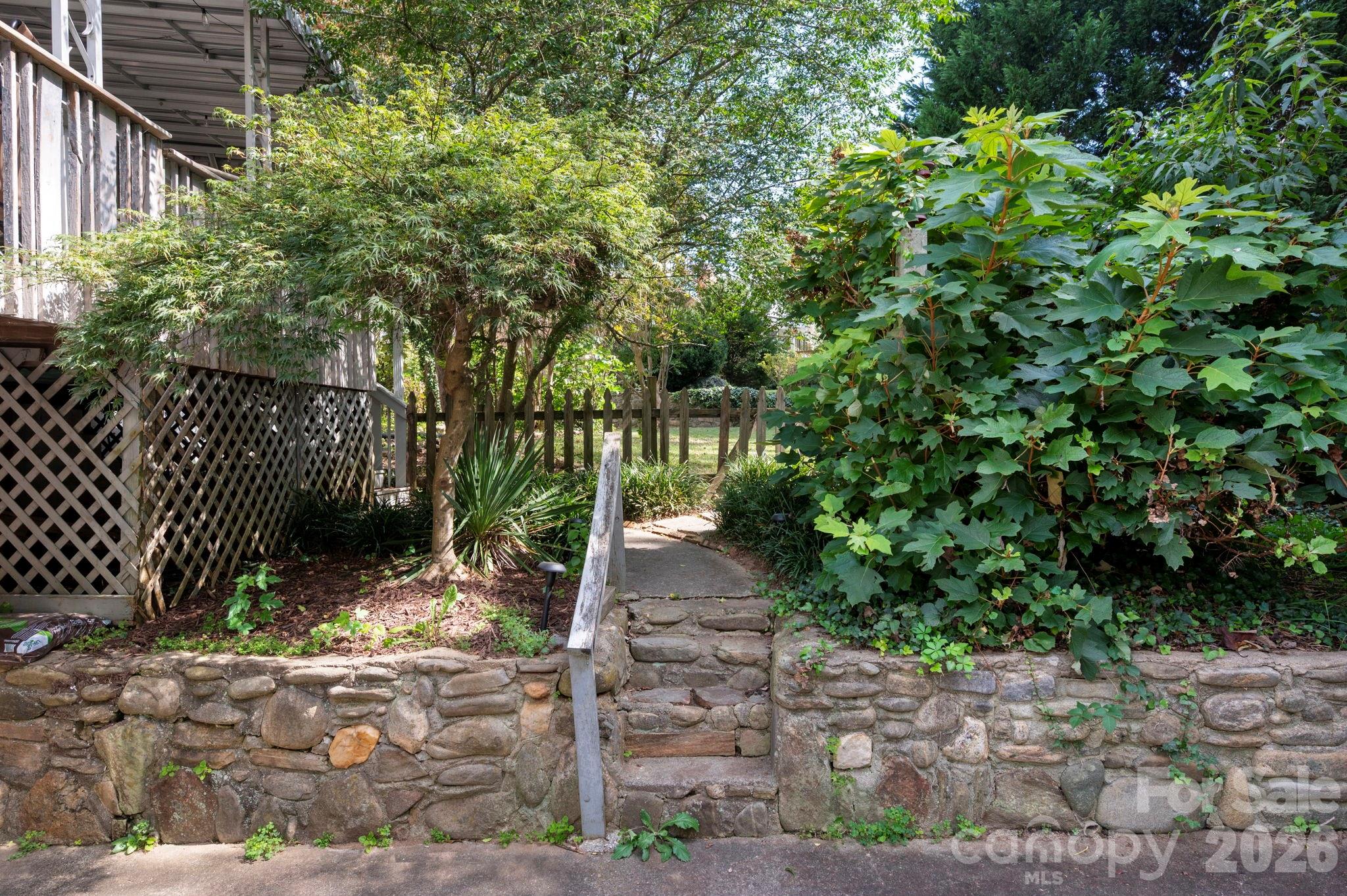 Stone walls and steps lead to the backyard - 109 Wilshire Drive, Asheville
