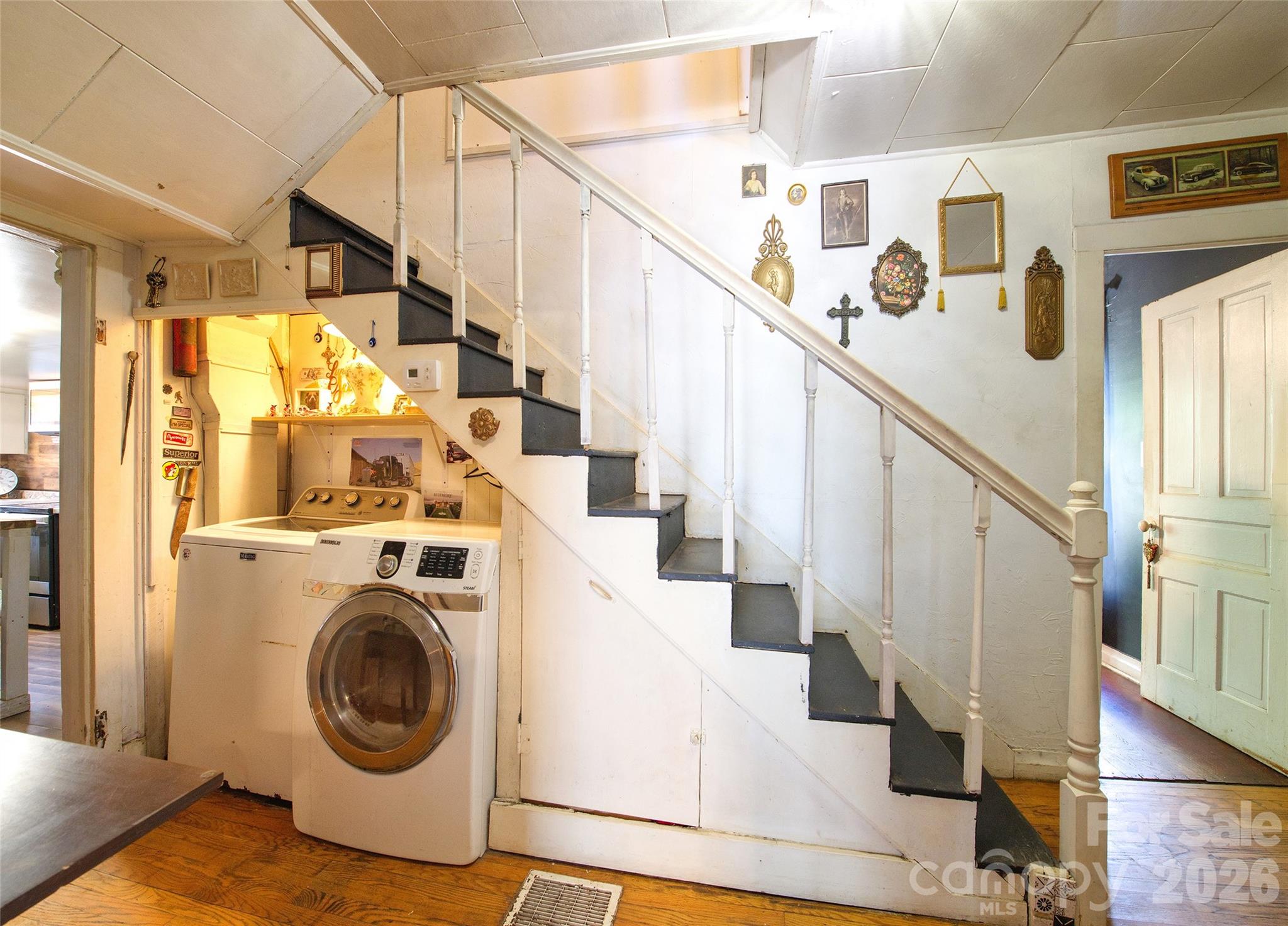 Laundry on main floor tucked away under the archietcctral stair case - 159 Ballew Street, Canton