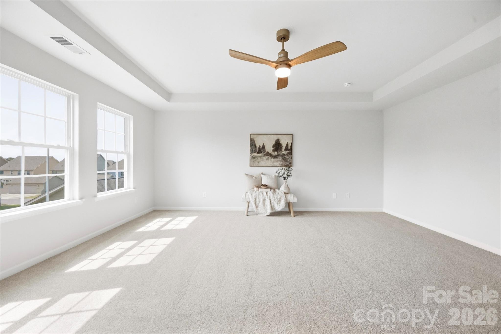 New ceiling fan adds a stylish and functional finishing touch to the primary suite - 2015 Kensley Drive, Waxhaw