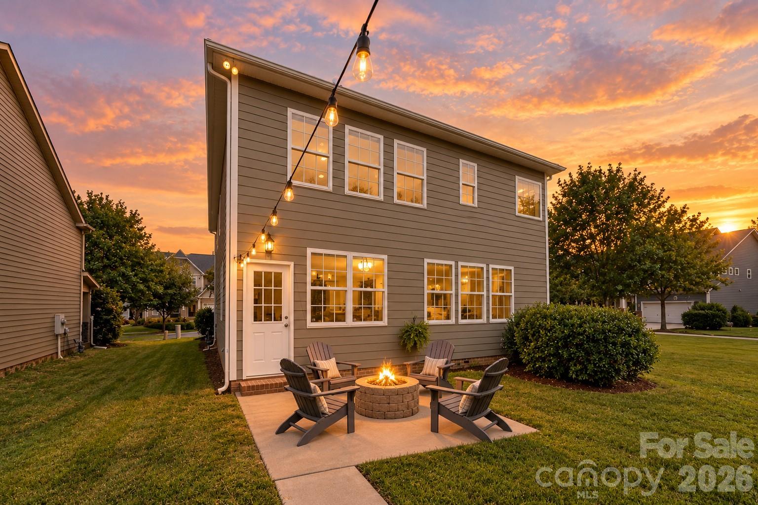 Inviting backyard patio creates the perfect setting for relaxing or entertaining around the fire pit - 2015 Kensley Drive, Waxhaw