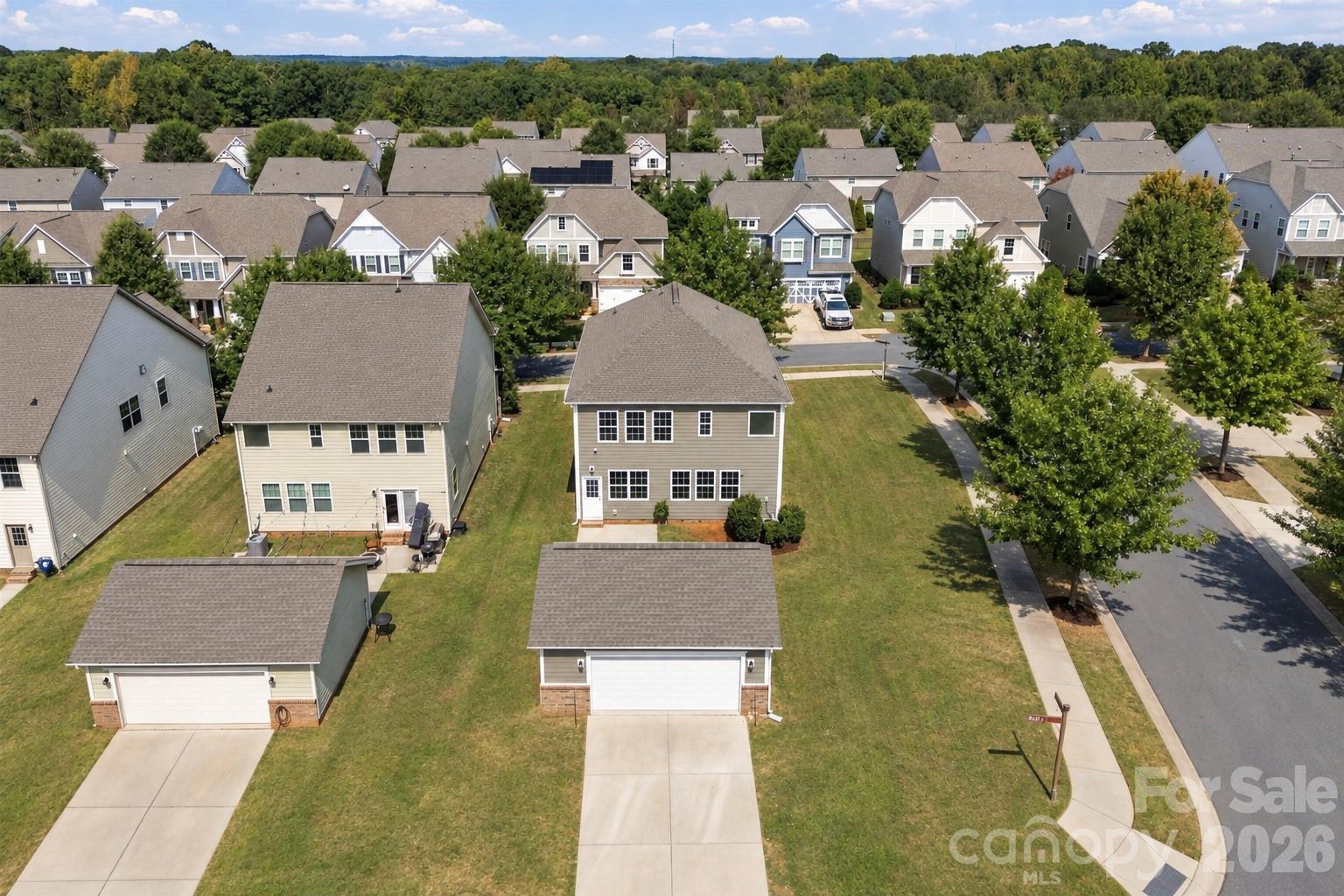 Aerial view showcases the home’s desirable corner setting, detached two-car garage, and generous surrounding yard - 2015 Kensley Drive, Waxhaw
