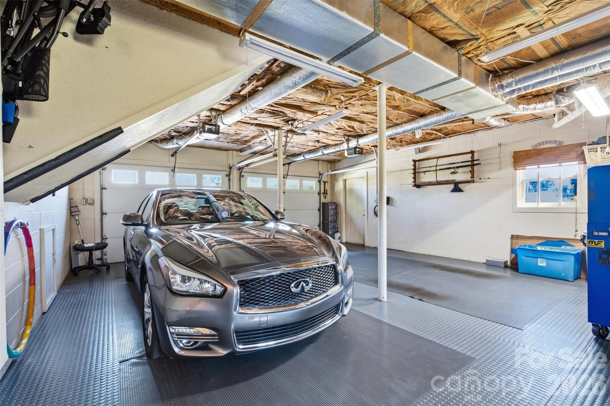 Garage with sealed floors and vinyl mats. - 118 Sherwood Drive, Taylorsville