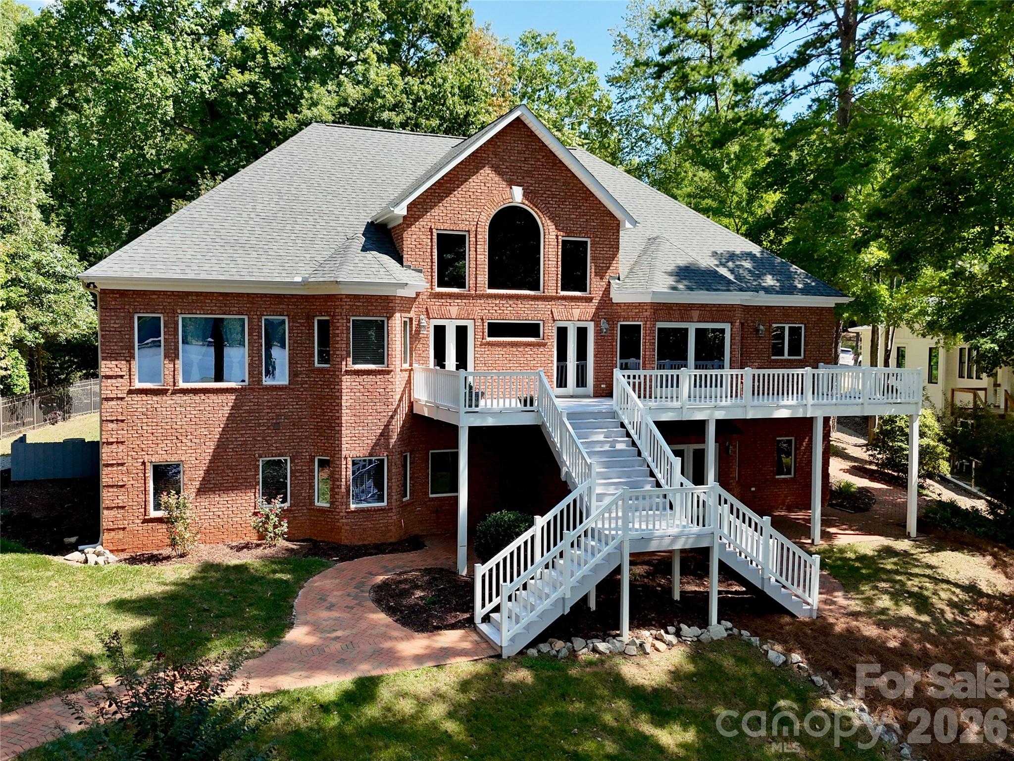 Custom-built brick home with stunning architectural brick design featuring arches, brick paver sidewalks, patio, & basement flooring. - 140 Holt Lane, Mooresville