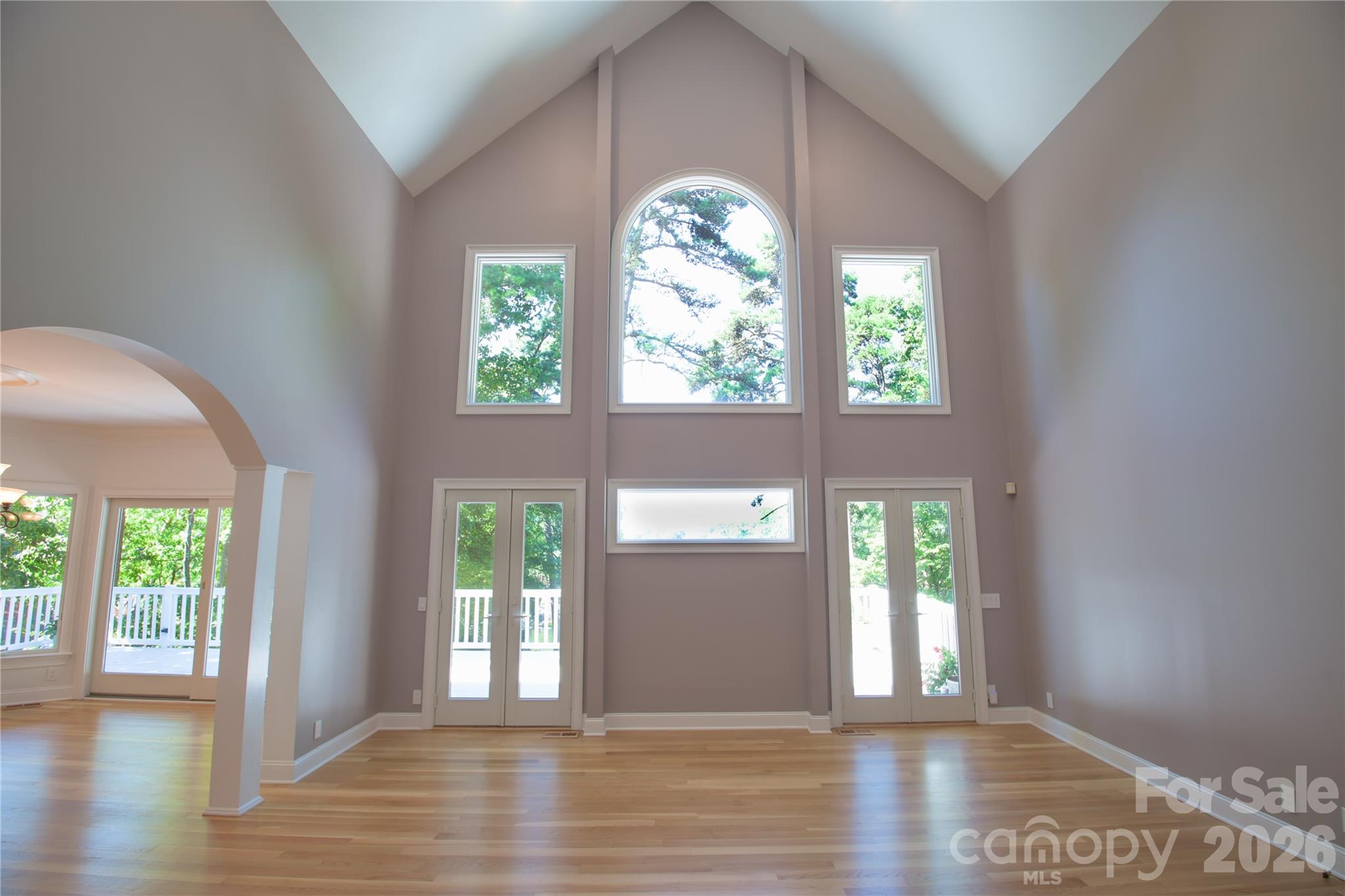 Cathedral ceiling with french doors and windows in great room looking out to water - 140 Holt Lane, Mooresville