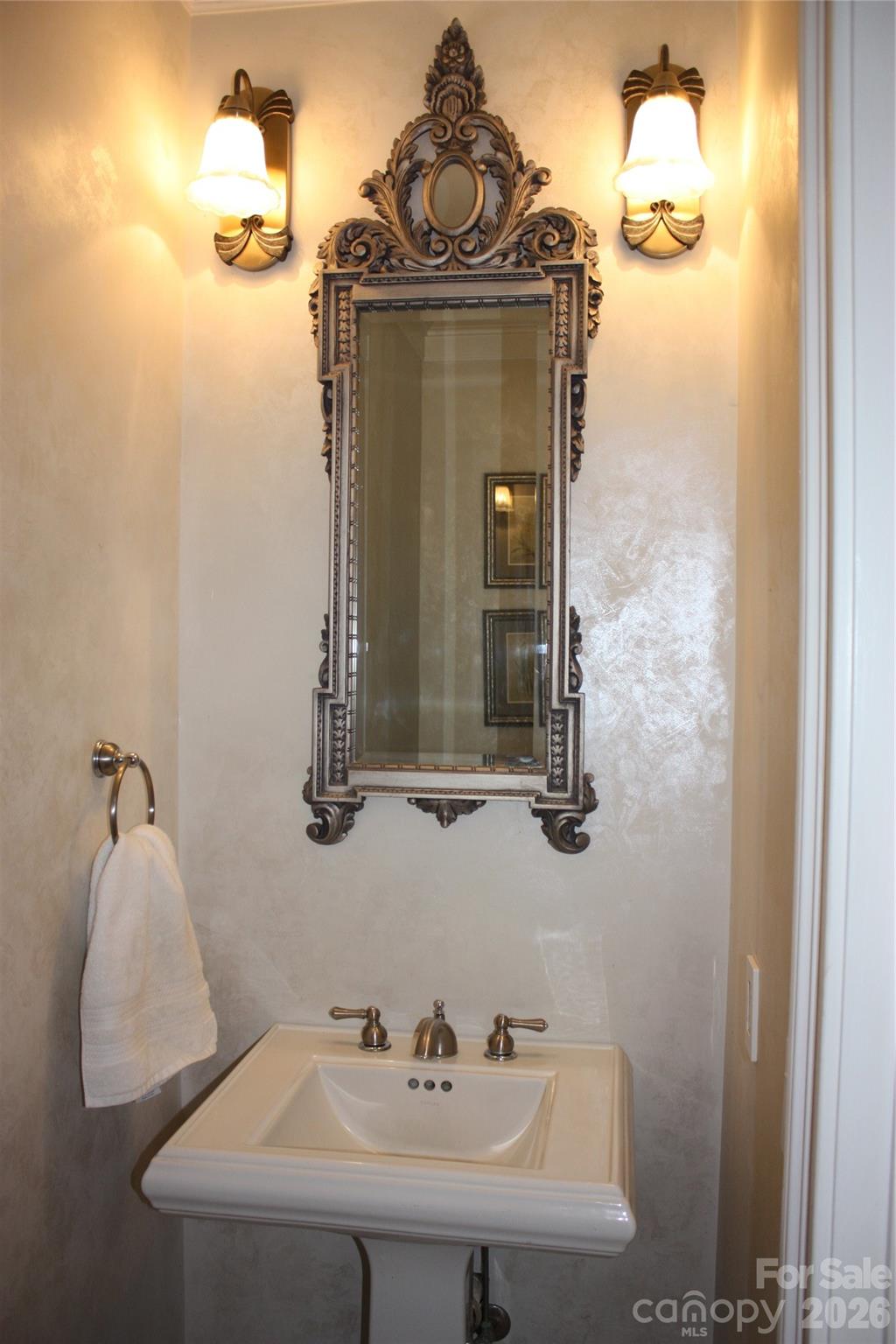 Pedestal sink, mirror, sconces to dress up your half bath. - 140 Holt Lane, Mooresville