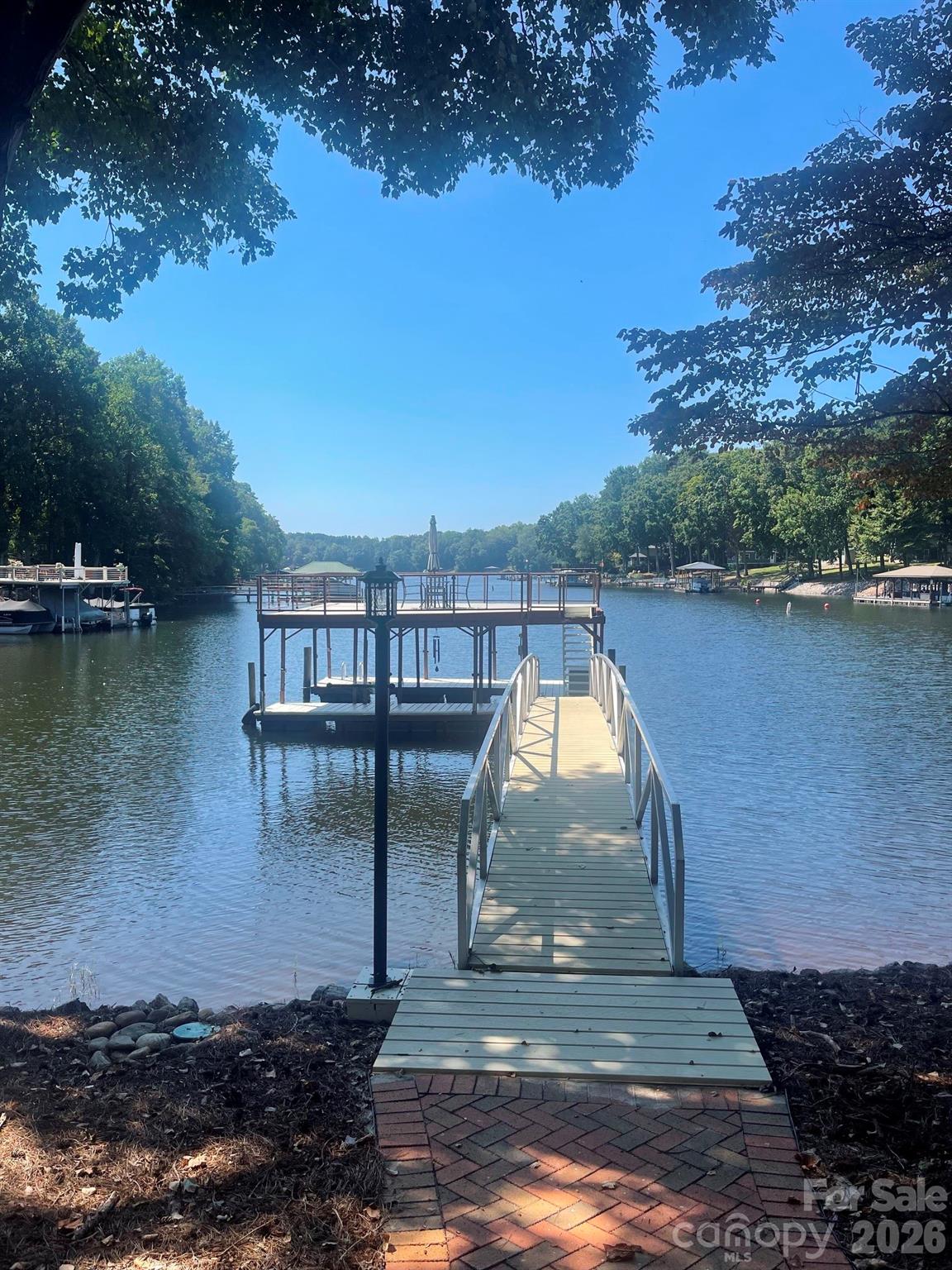 Brick pavers lead you down to your arched aluminum gangway over to your dock. - 140 Holt Lane, Mooresville