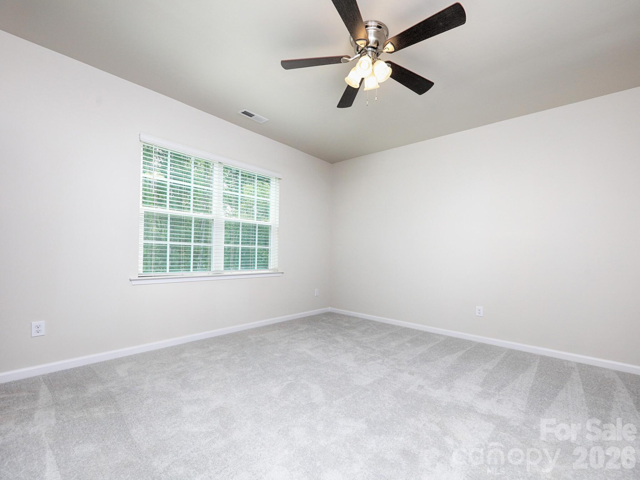 Primary bedroom has ceiling fan - 121 Olive Tea Lane, Statesville