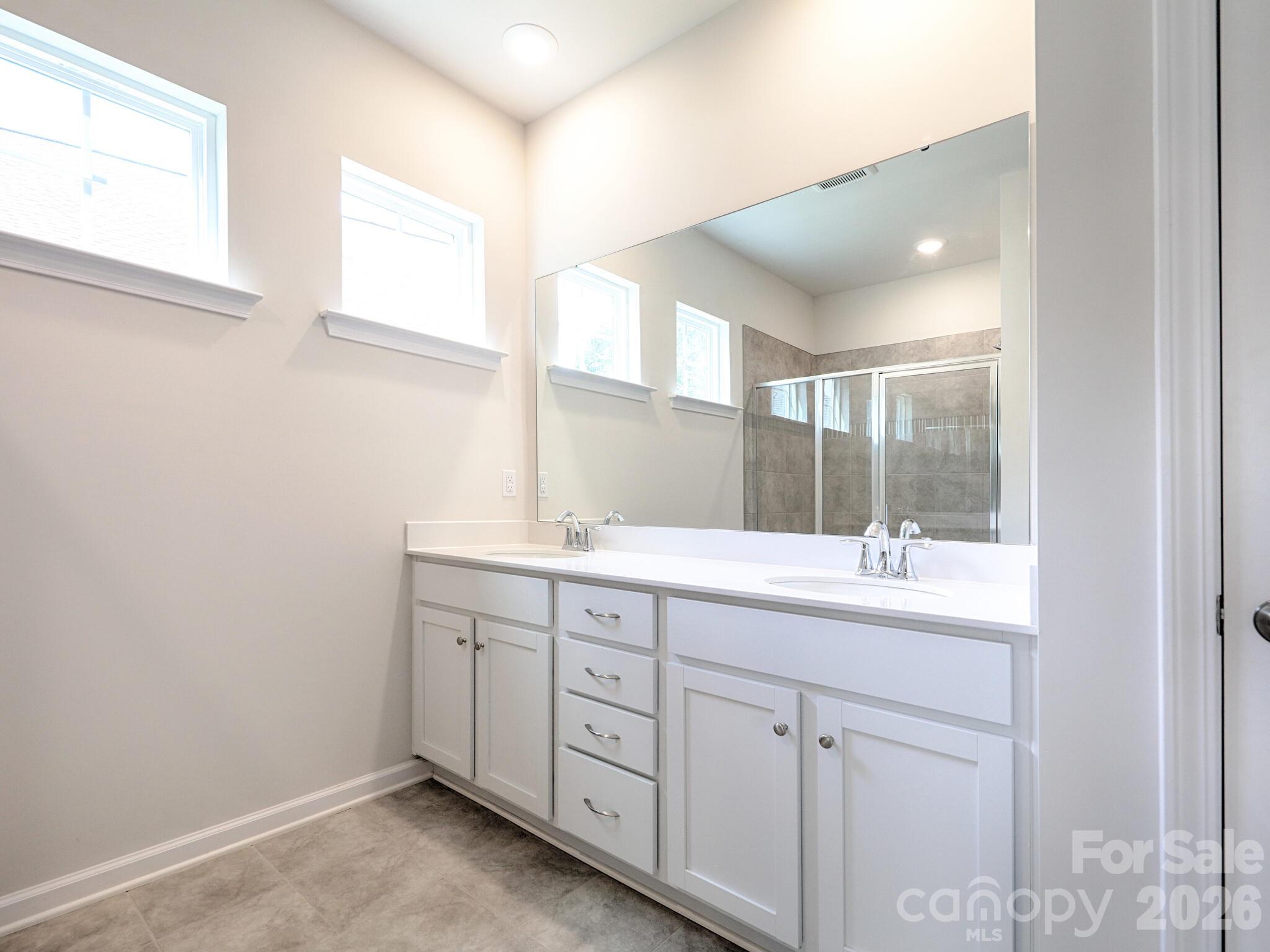 Primary ensuite bathroom with dual basin vanity - 121 Olive Tea Lane, Statesville