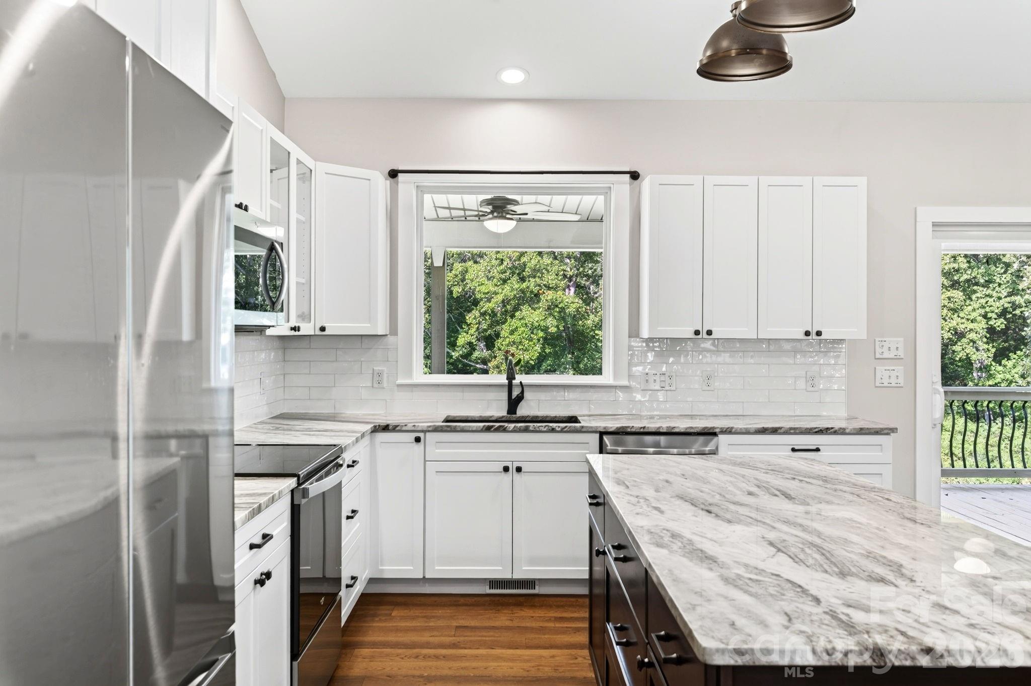 Kitchen upgraded with additional upper cabinetry and backsplash - 139 Ridge Road, Candler