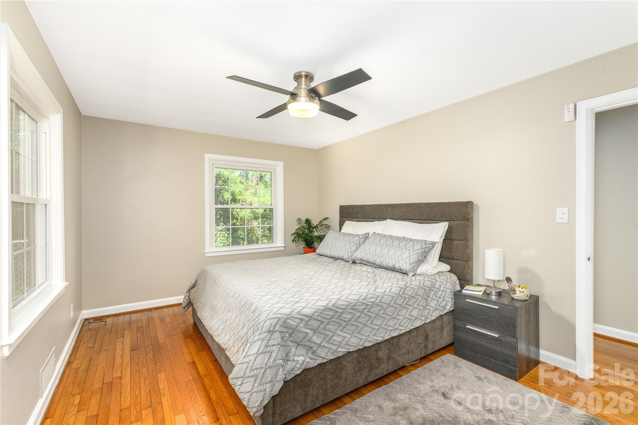 Primary bedroom easily accommodates a king size bed. Lots of natural light from windows facing the side and rear of the home. - 111 Gracelyn Road, Asheville