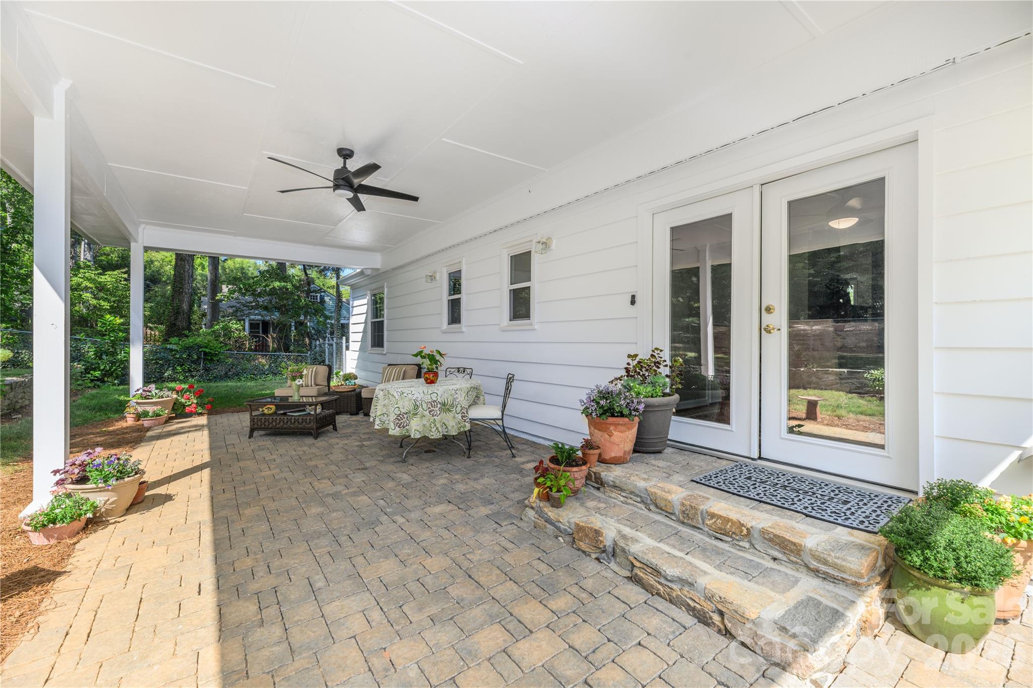 Large covered paver patio, just off the dining area, in the rear private fenced yard. - 111 Gracelyn Road, Asheville