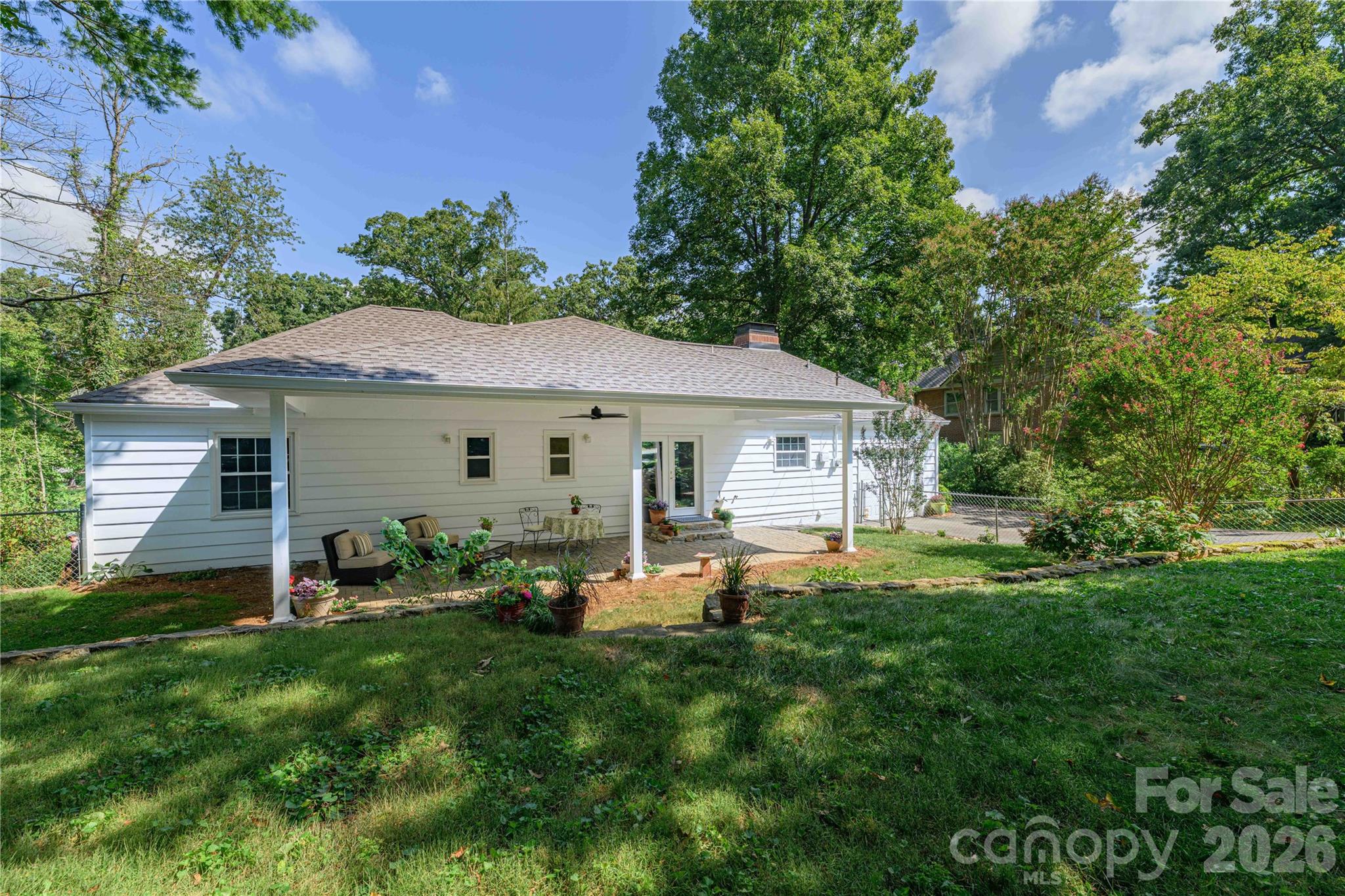 Rear view of the home and covered patio. - 111 Gracelyn Road, Asheville
