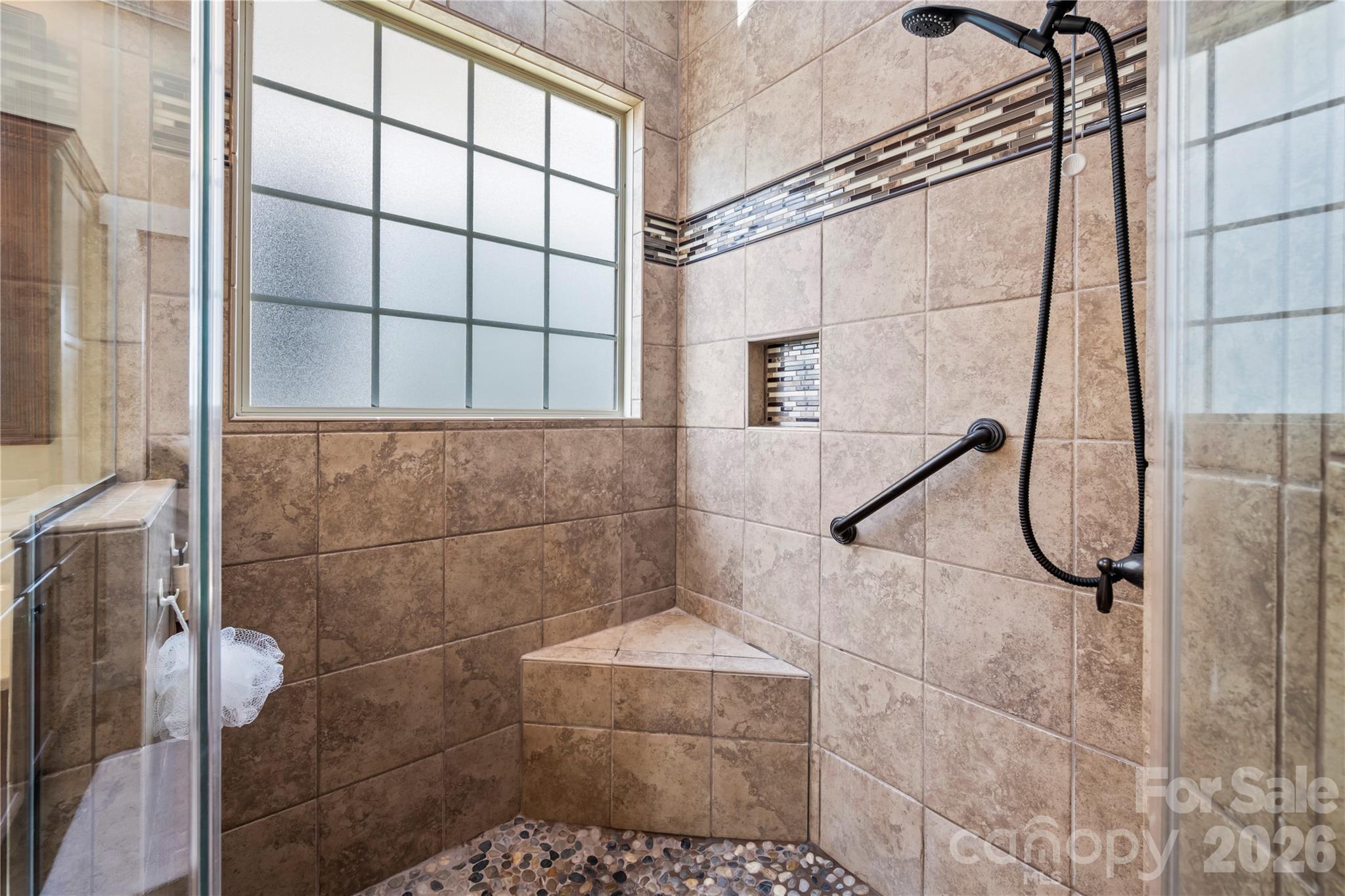 Primary bath has pebbled zero entry shower - 27 Dreambird Drive, Leicester