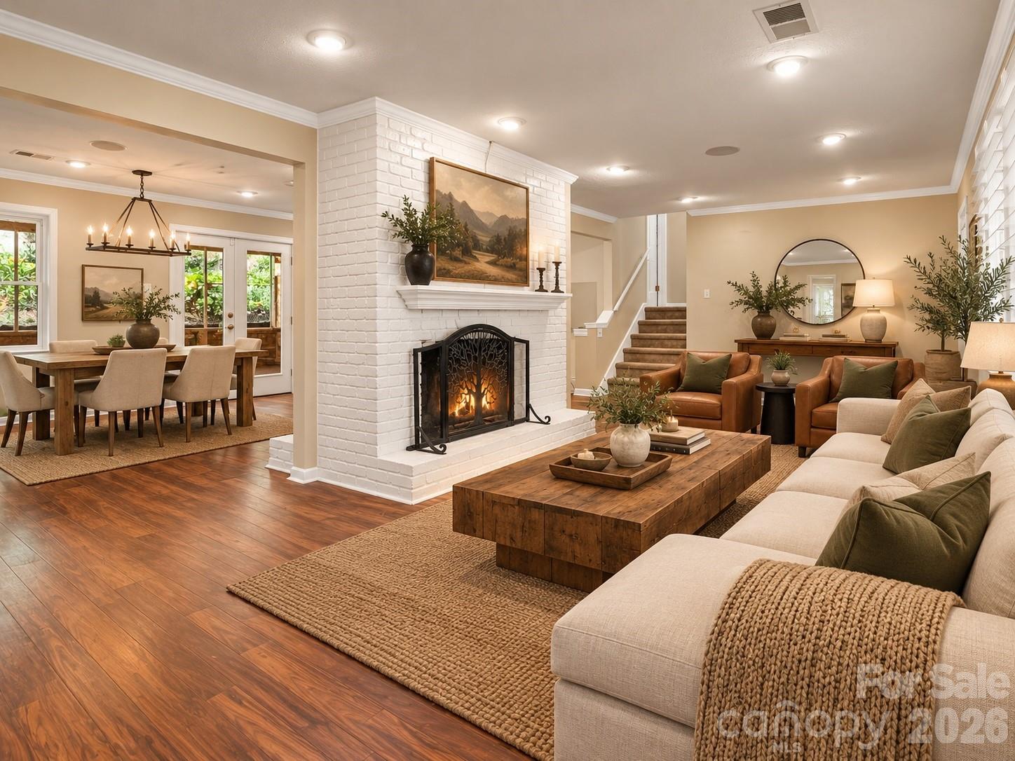 Beautiful double sided gas log fireplace separating the living space from the dining room. AI generated virtual staging. - 111 Dogwood Drive, Black Mountain