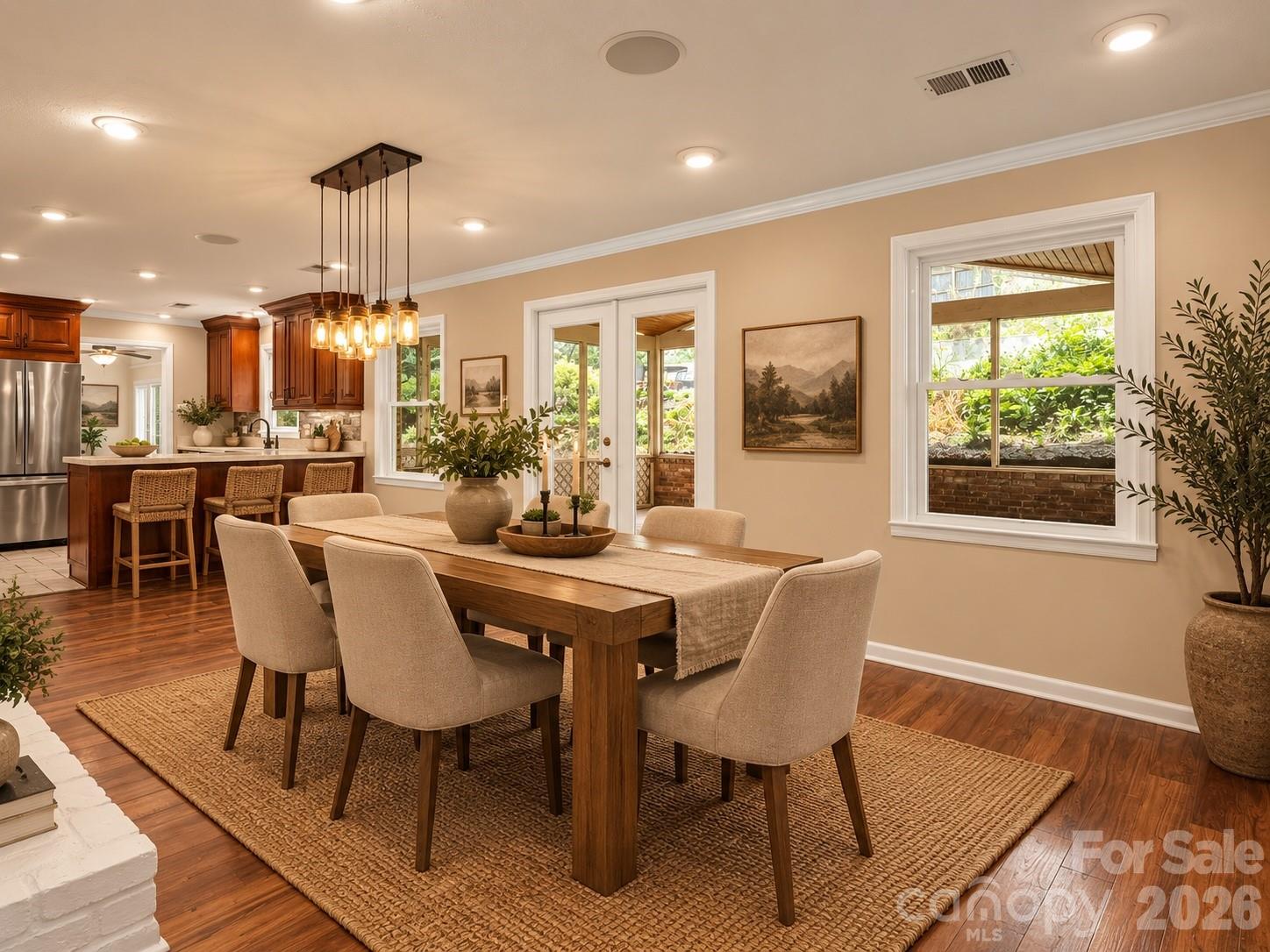 Beautiful dining area open to the kitchen and direct access to the screened back porch. AI generated virtual staging. - 111 Dogwood Drive, Black Mountain