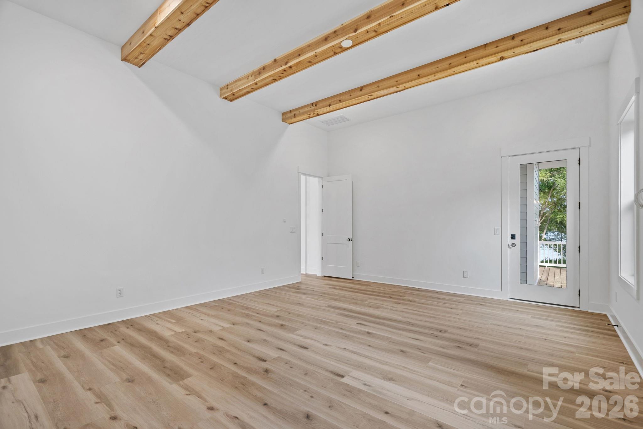 Primary Suite with 12-foot ceilings and access to deck. - 4477 Splash Trail, Sherrills Ford