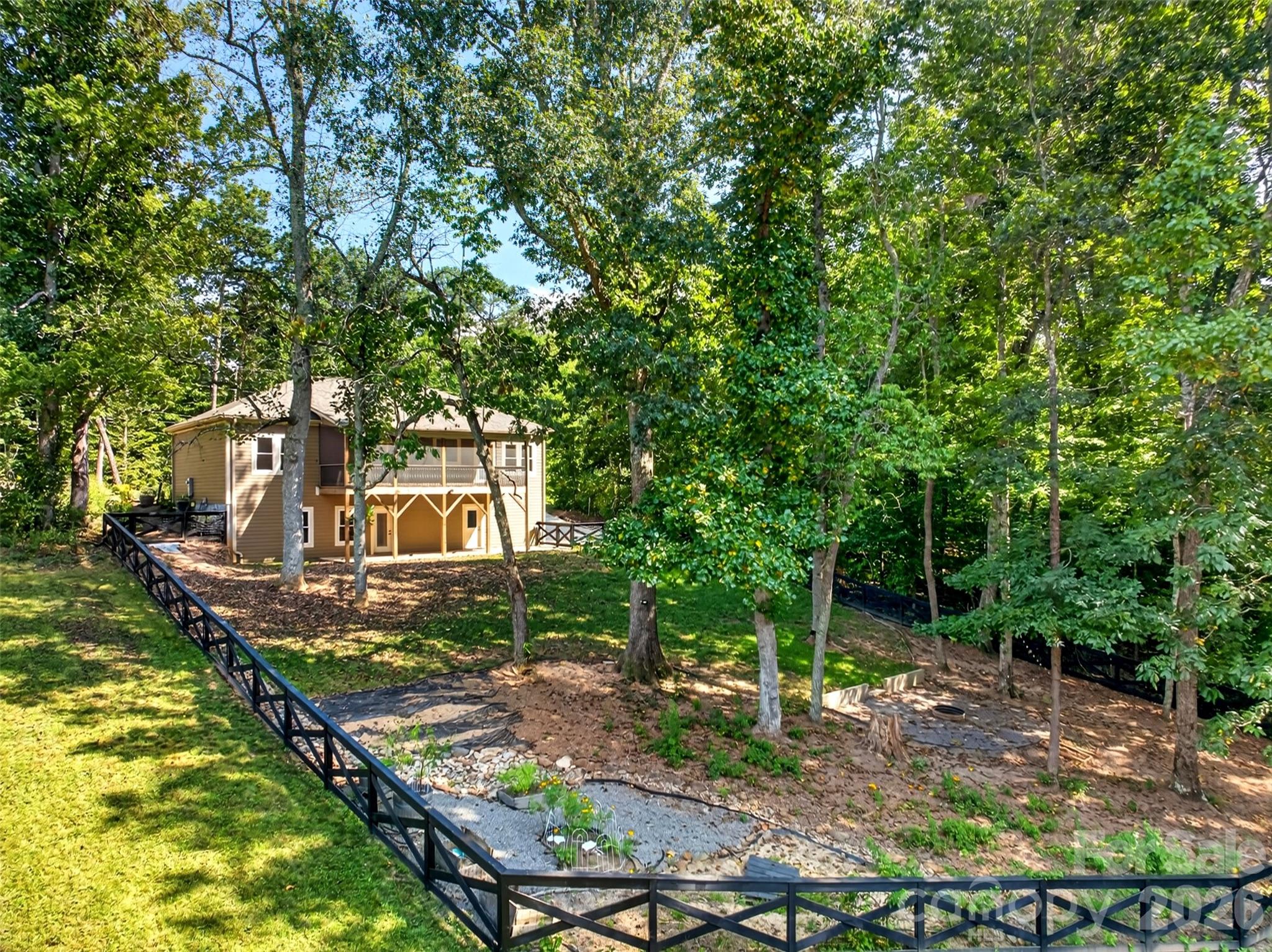 completely fenced-in backyard with firepit and gardens and mature trees - 131 Ridge Road, Candler