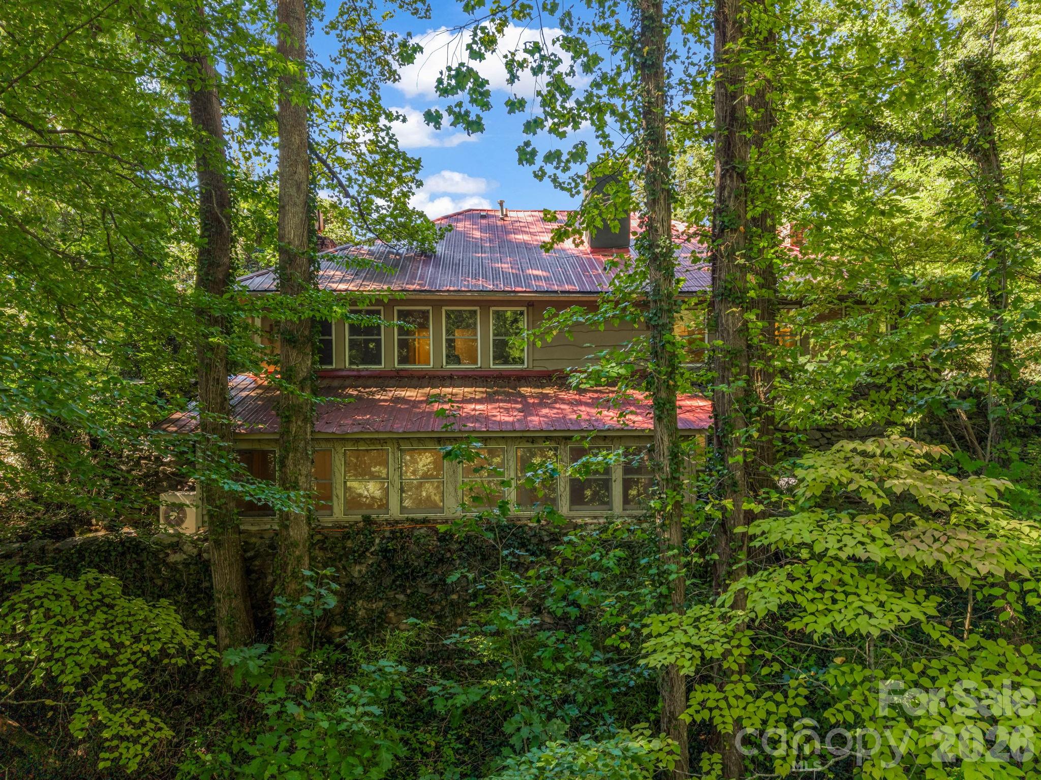 Back view of the main level and basement - 145 Stone Hedge Lane, Tryon