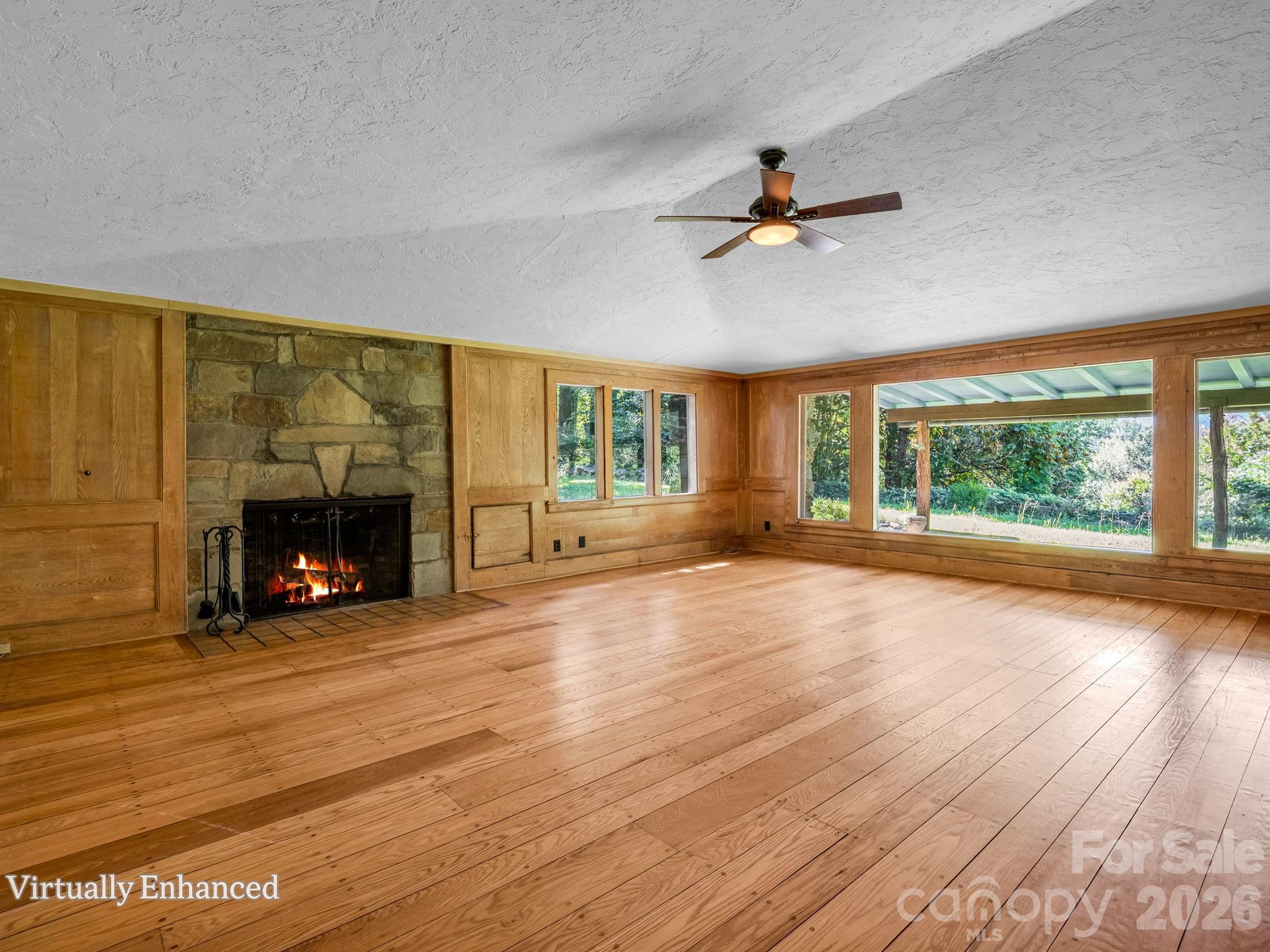 Wood burning fireplace with two-sided firewood storage compartment on the right - 145 Stone Hedge Lane, Tryon