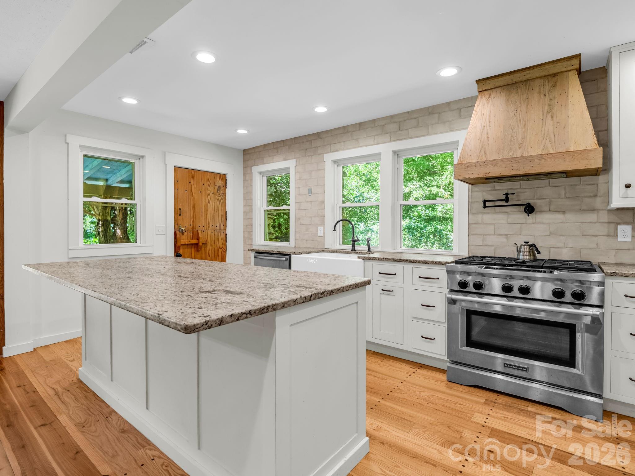 Gas range oven with exhaust hood and pot filler faucet - 145 Stone Hedge Lane, Tryon