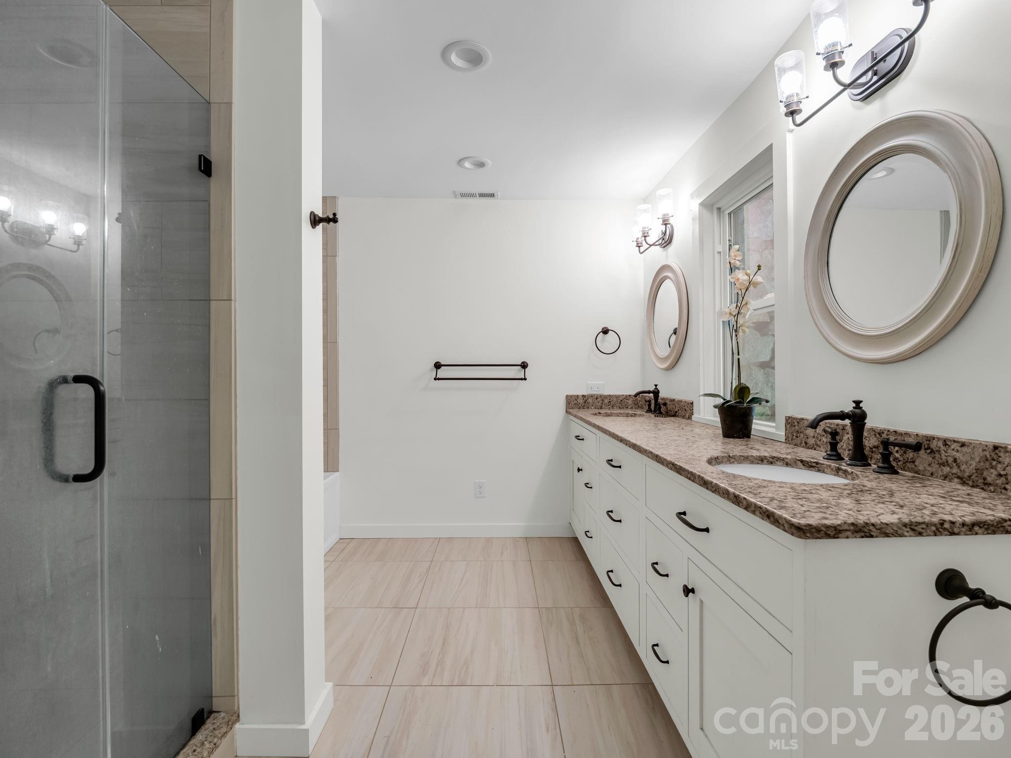 Primary tile bathroom with shower and tub, double vanity and solid surface counters - 145 Stone Hedge Lane, Tryon