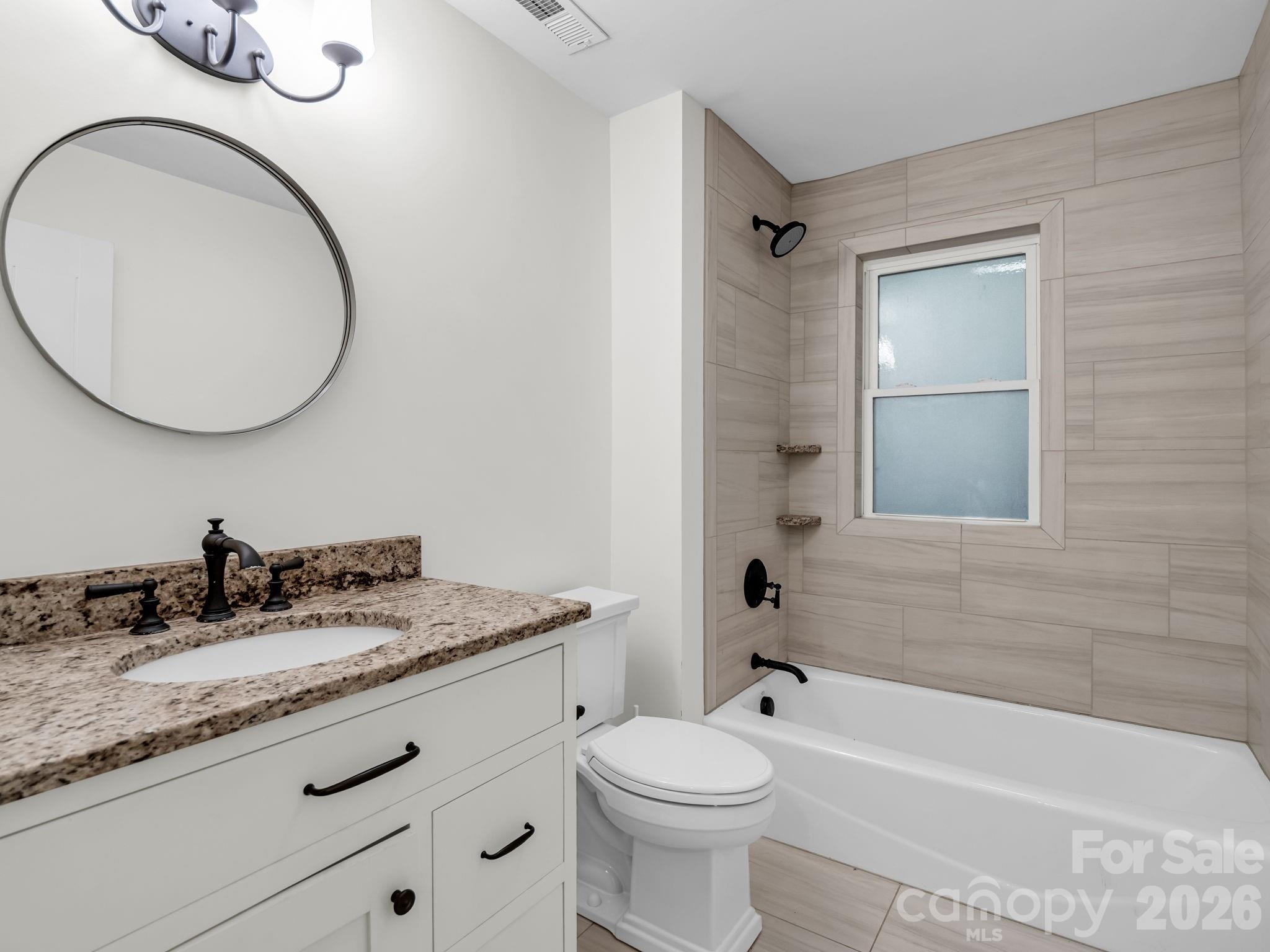 Guest bathroom with tile and solid surface vanity top - 145 Stone Hedge Lane, Tryon