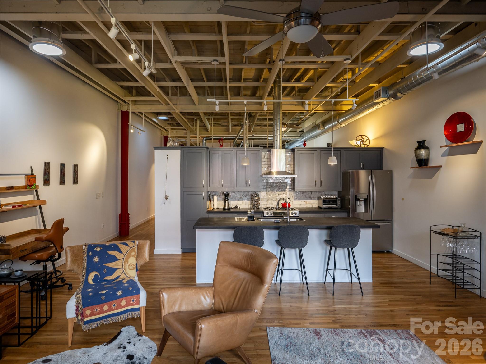 Kitchen island with concrete countertops and stainless appliances - 15 Rankin Avenue, Asheville