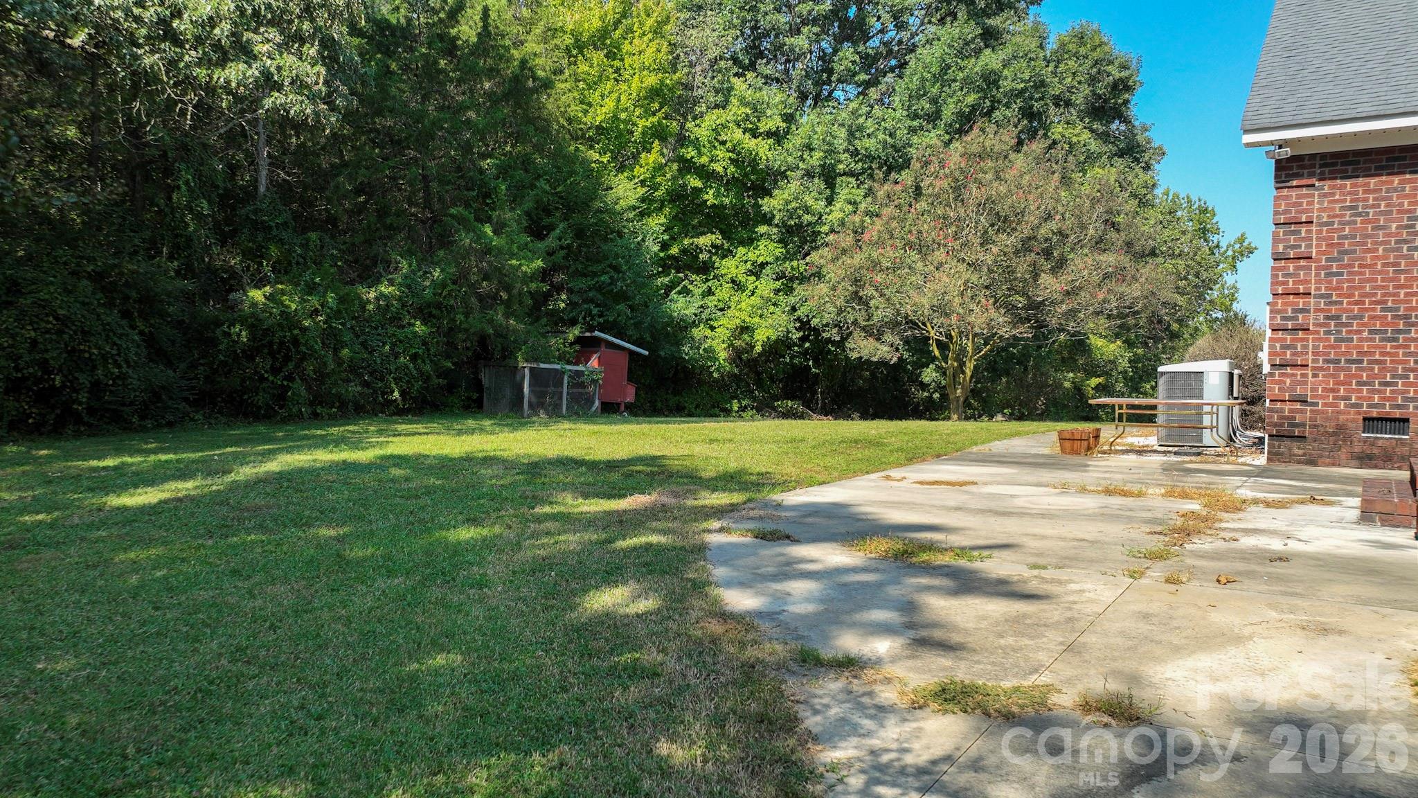 Side yard with patio leading to laundry room hallway - 5526 Old Kennedy Ford Road, Marshville