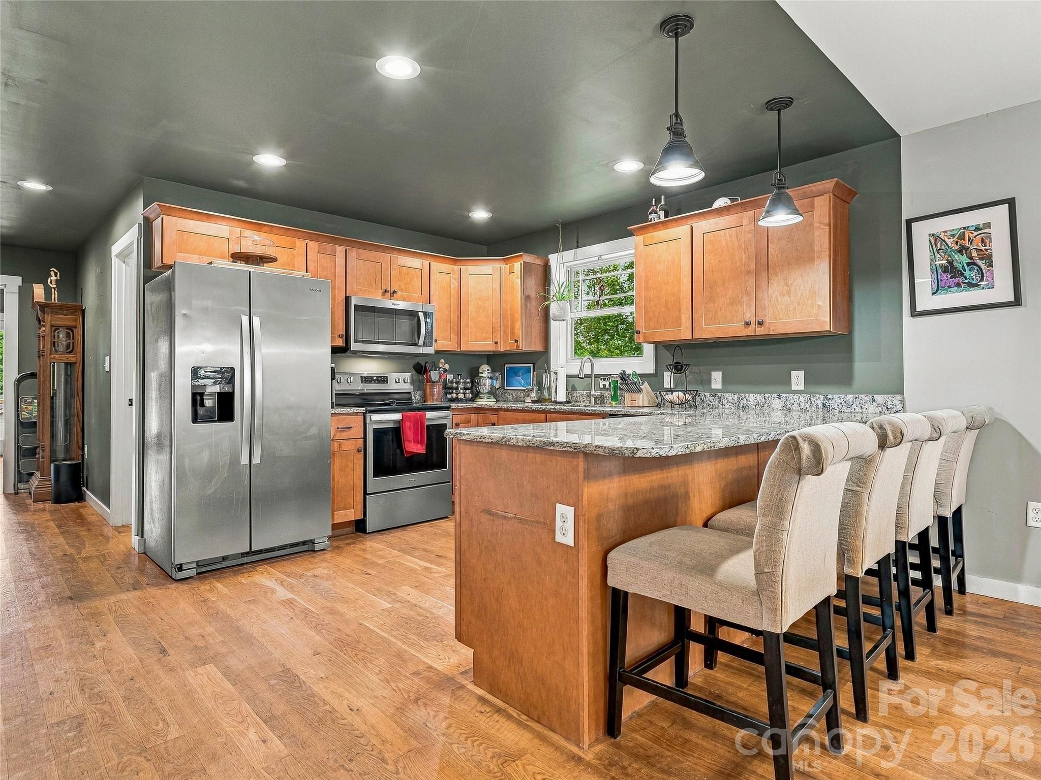 Open kitchen with bar top seating. The kitchen also includes a pantry - 1884 Bear Creek Road, Leicester