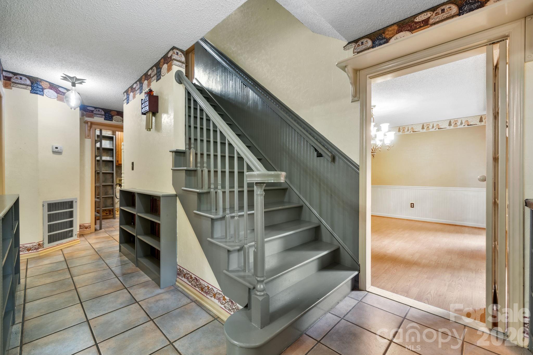 entry foyer leading to dining room on right and living room on left - 3110 Ninth Tee Drive, Newton