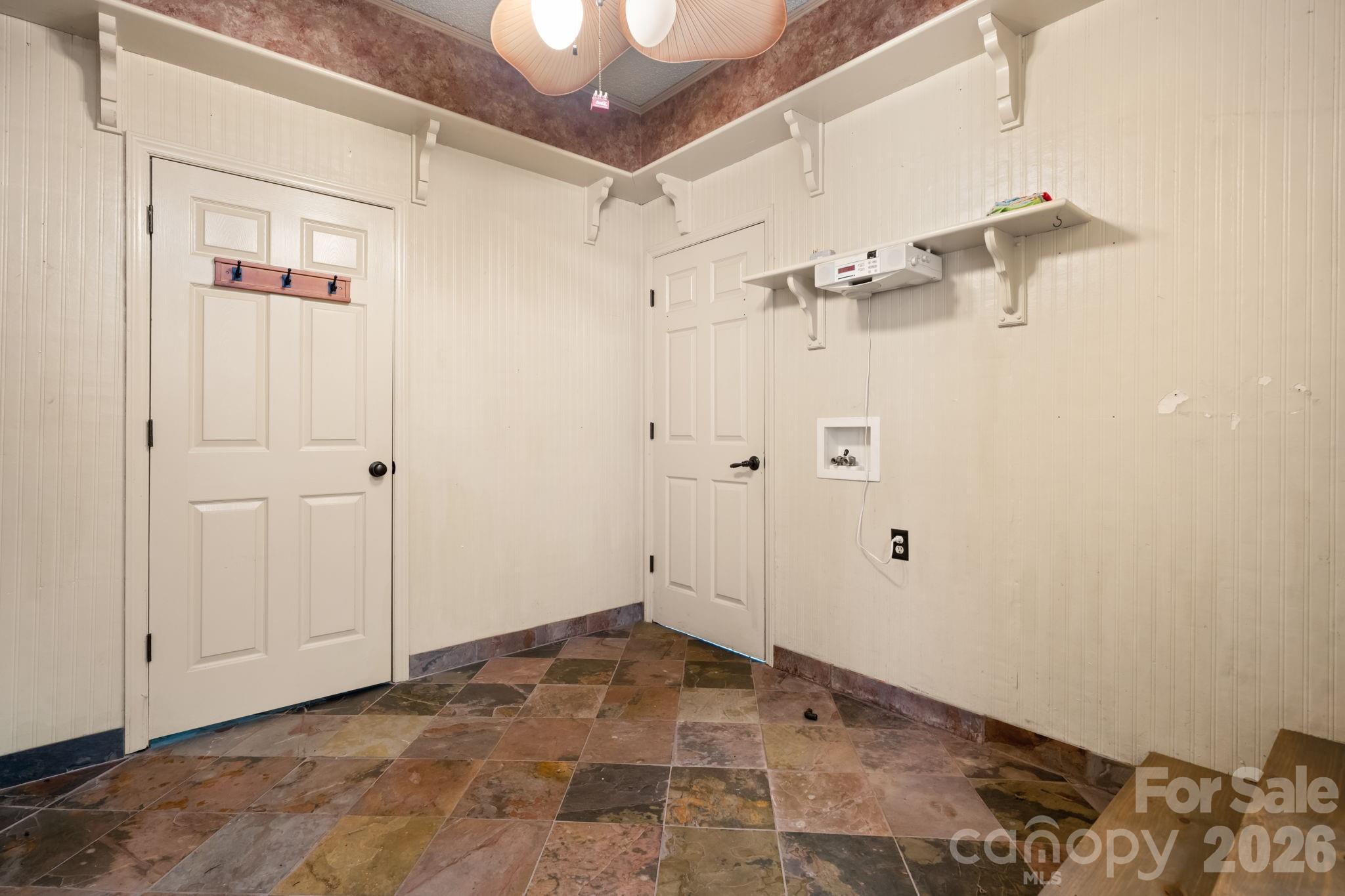laundry room area with storage/pantry door and door to garage - 3110 Ninth Tee Drive, Newton