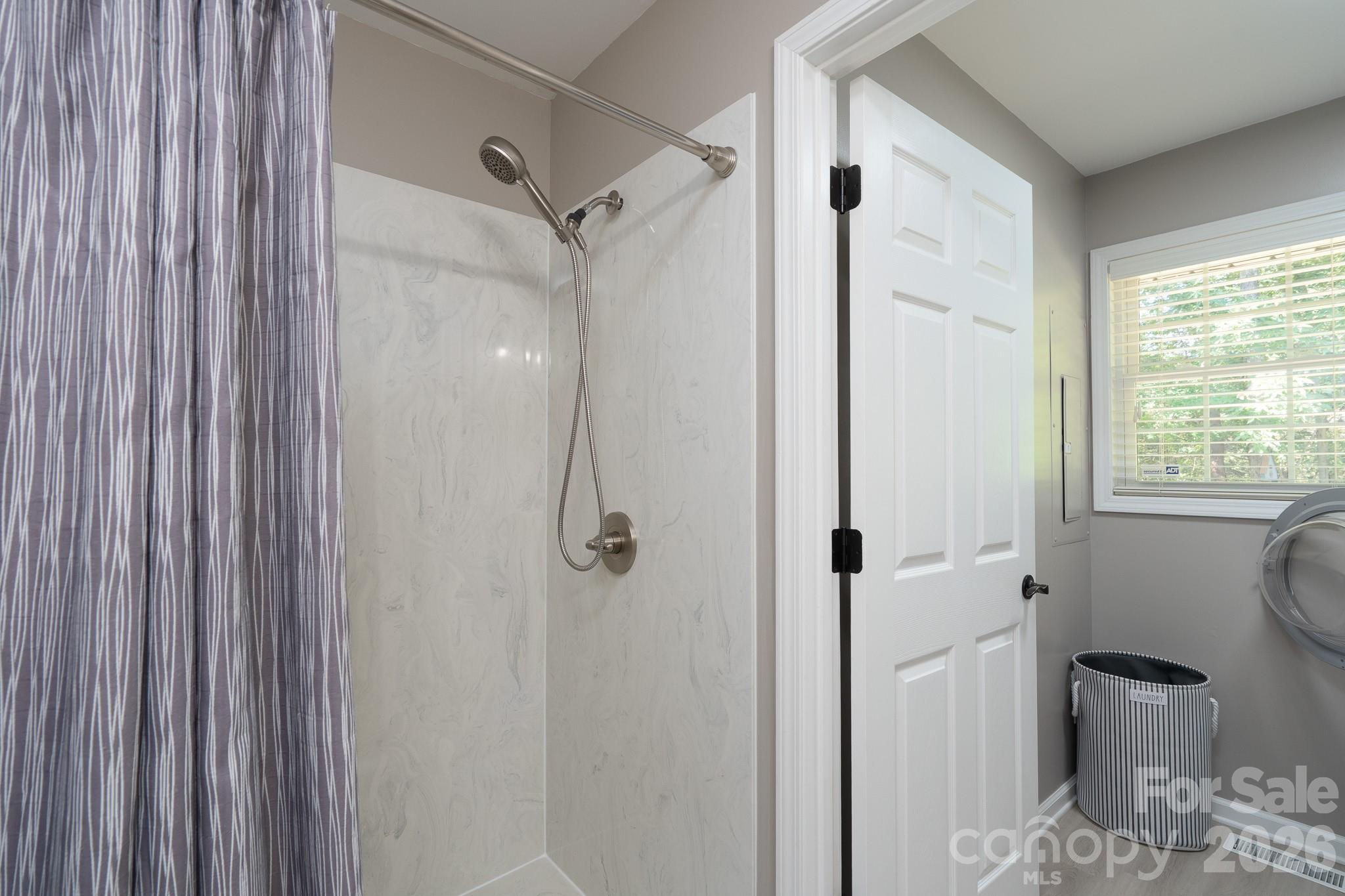 Second full bathroom with attached laundry room on main level. - 309 Imperial Way, Albemarle